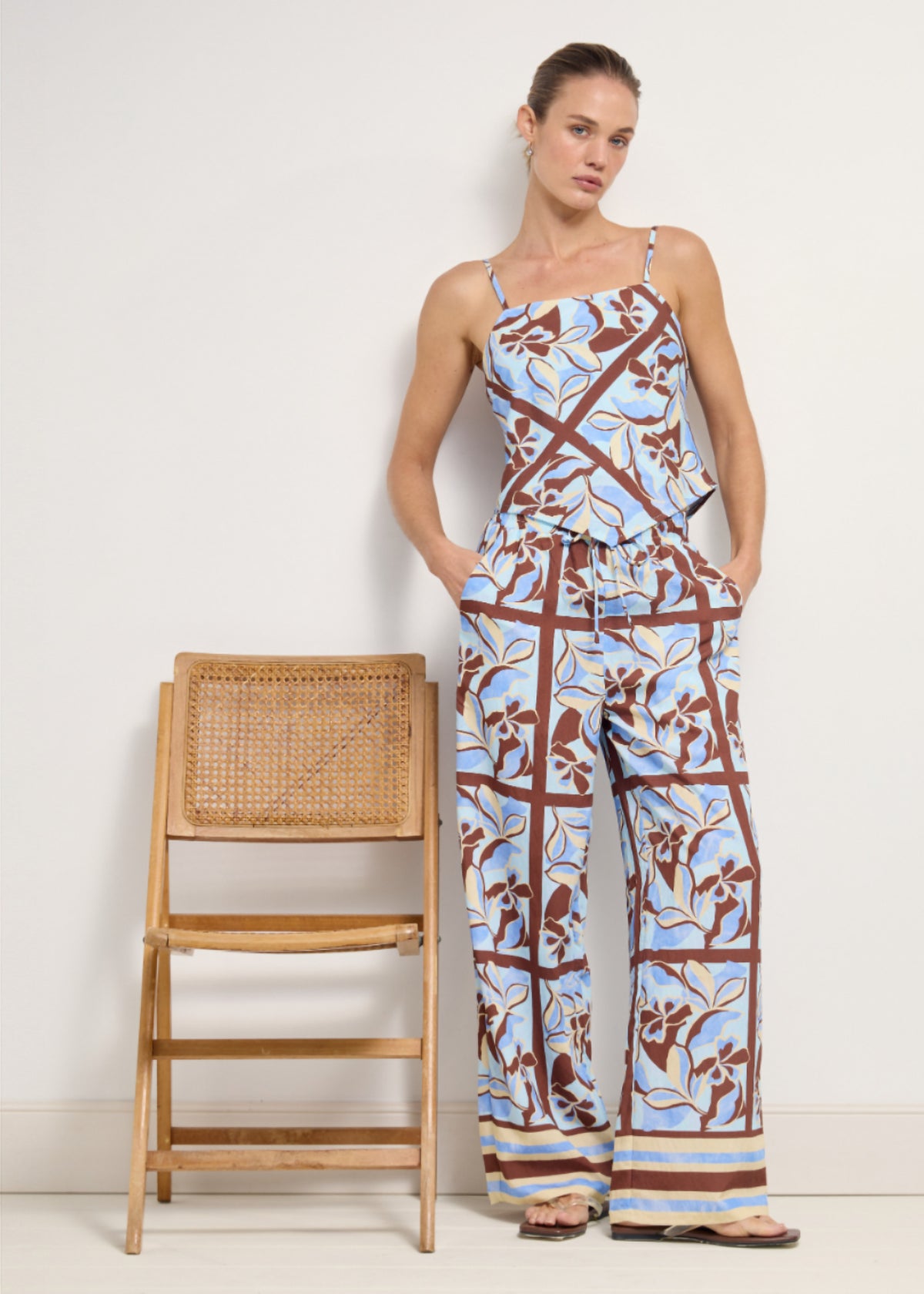 Model wearing Blue Abstract floral Wide-Leg Drawstring Pants with a full-length wide leg silhouette.