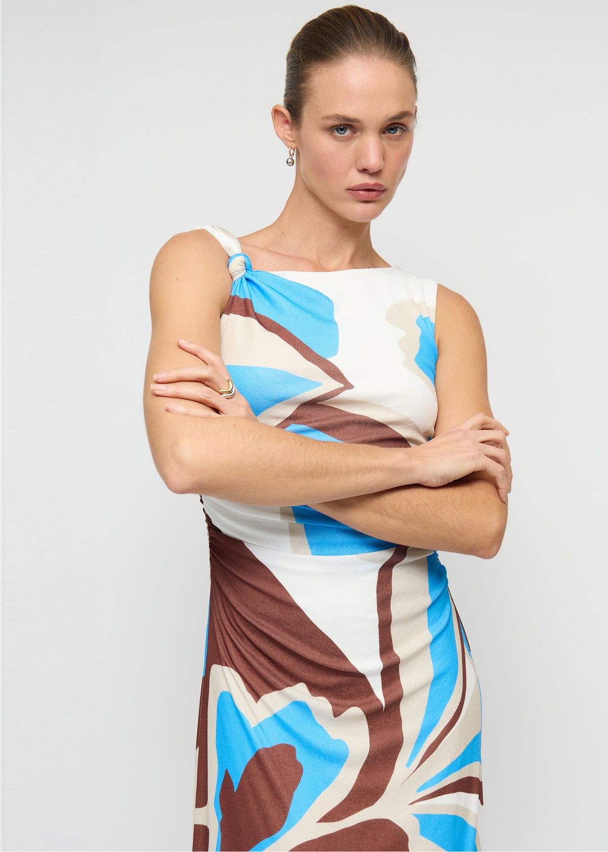 Close-up of the Blue Abstract Mesh Midi Dress, showing a one-shoulder neckline with knot detail.