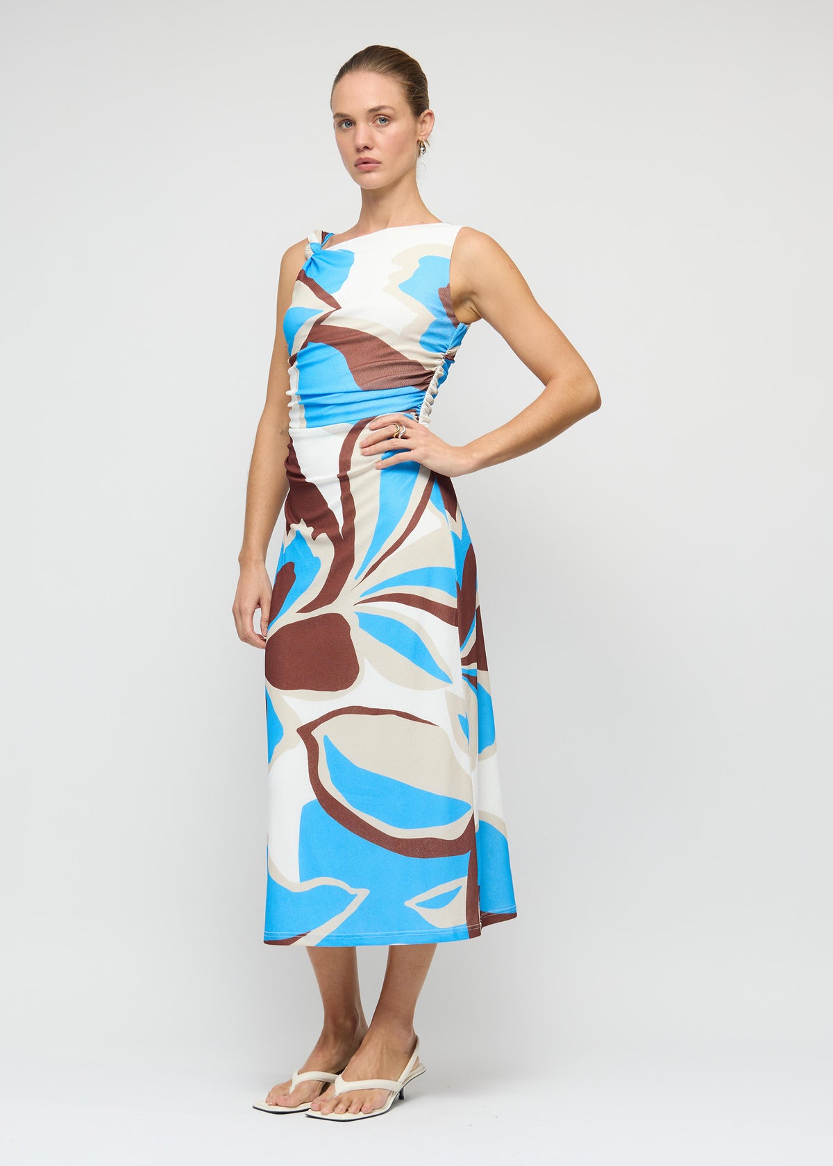 Model wearing Blue Abstract Mesh Midi Dress, showing a one-shoulder neckline with knot detail.