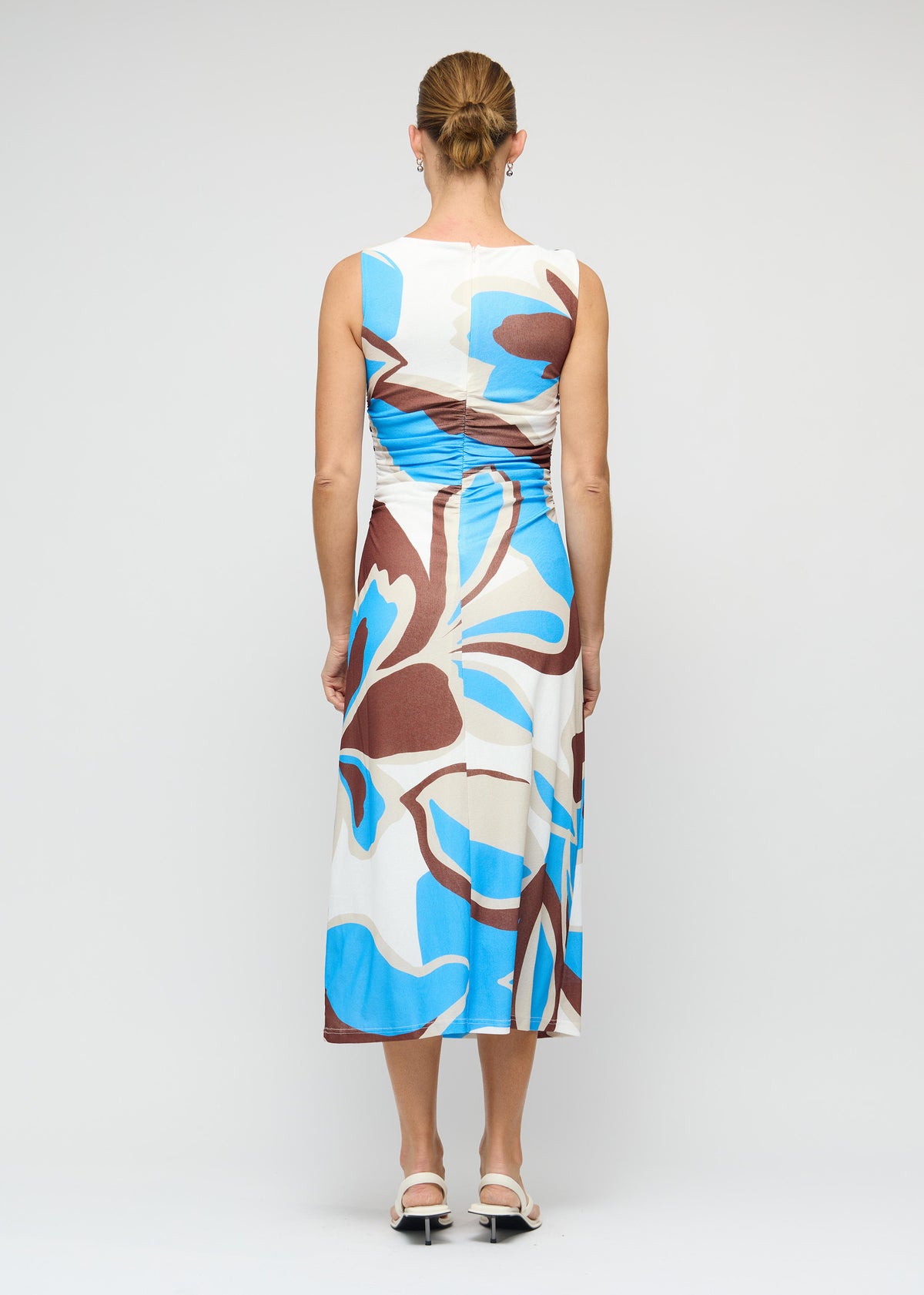 Back view of the Blue Abstract Mesh Midi Dress with a one-shoulder neckline with knot detail and a midi length with flattering side ruching.