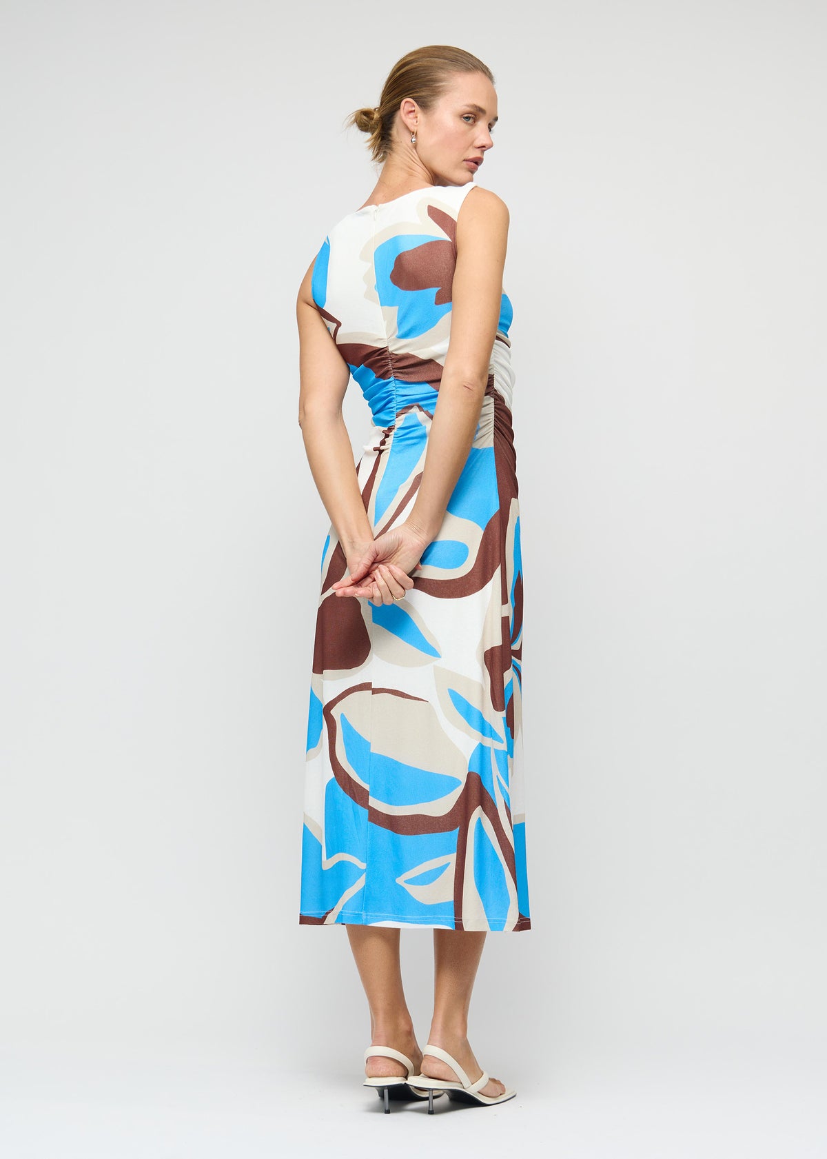 Angled view of the Blue Abstract Mesh Midi Dress with an abstract print exclusive to Staple the Label and a fully lined.