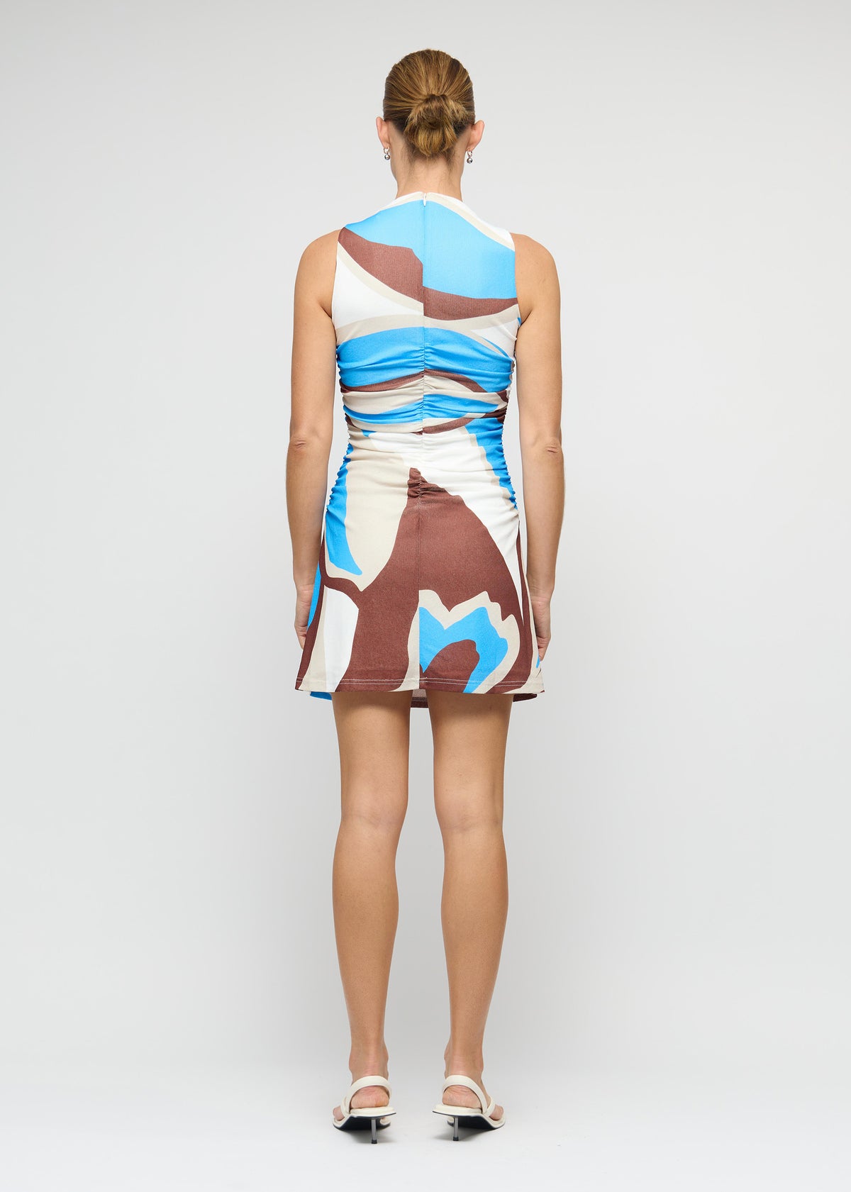 Back view of the Blue Abstract Mesh Mini Dress with a high neckline and sleeveless silhouette.