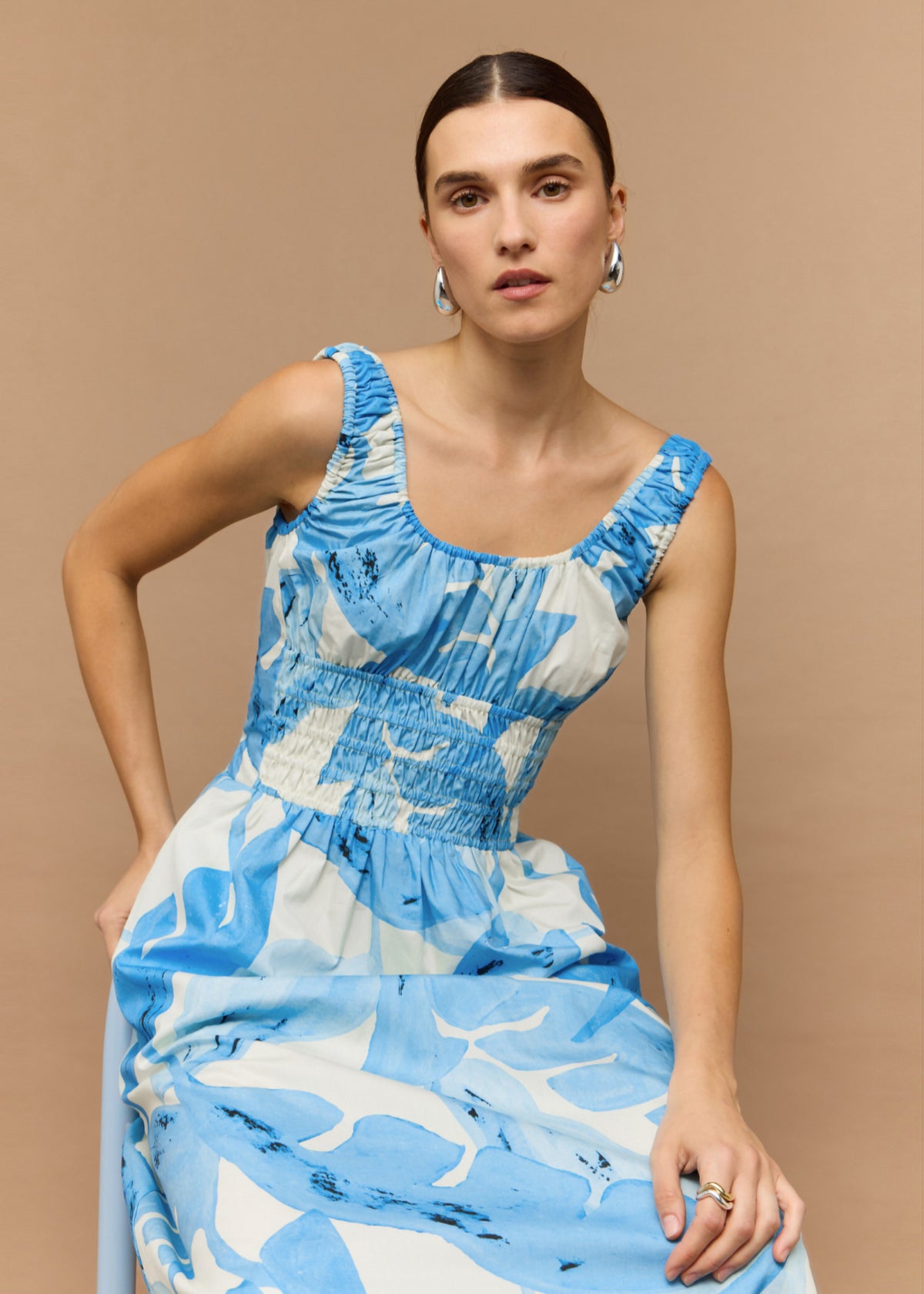 Close-up of the Blue and White Floral Cotton Shirred Midi Dress, showing a wide straps and scoop neckline.