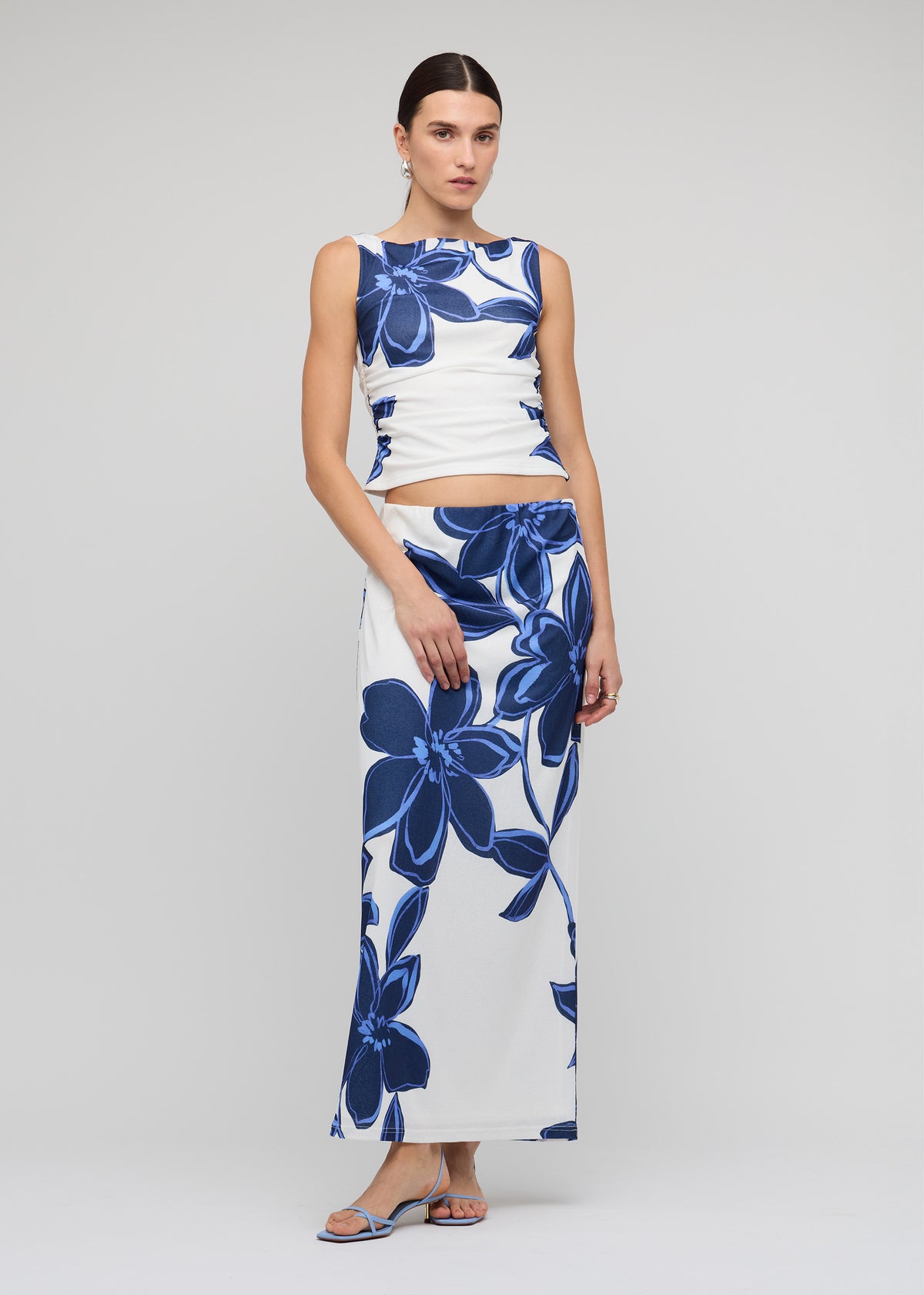 Model wearing Blue and White Floral Mesh Maxi Skirt, showing an elasticated waistband and a body-skimming silhouette, fully lined.