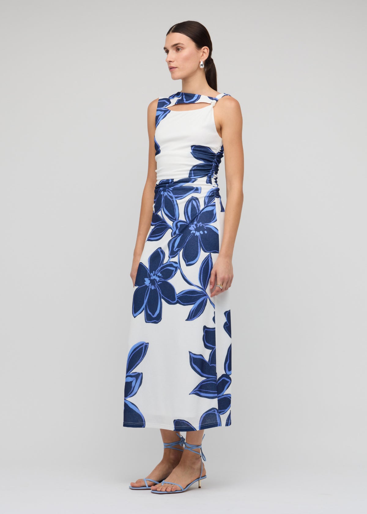 Side view of the Blue and White Floral Mesh Midi Dress, showing a sleeveless cut and a fully lined with stretch.