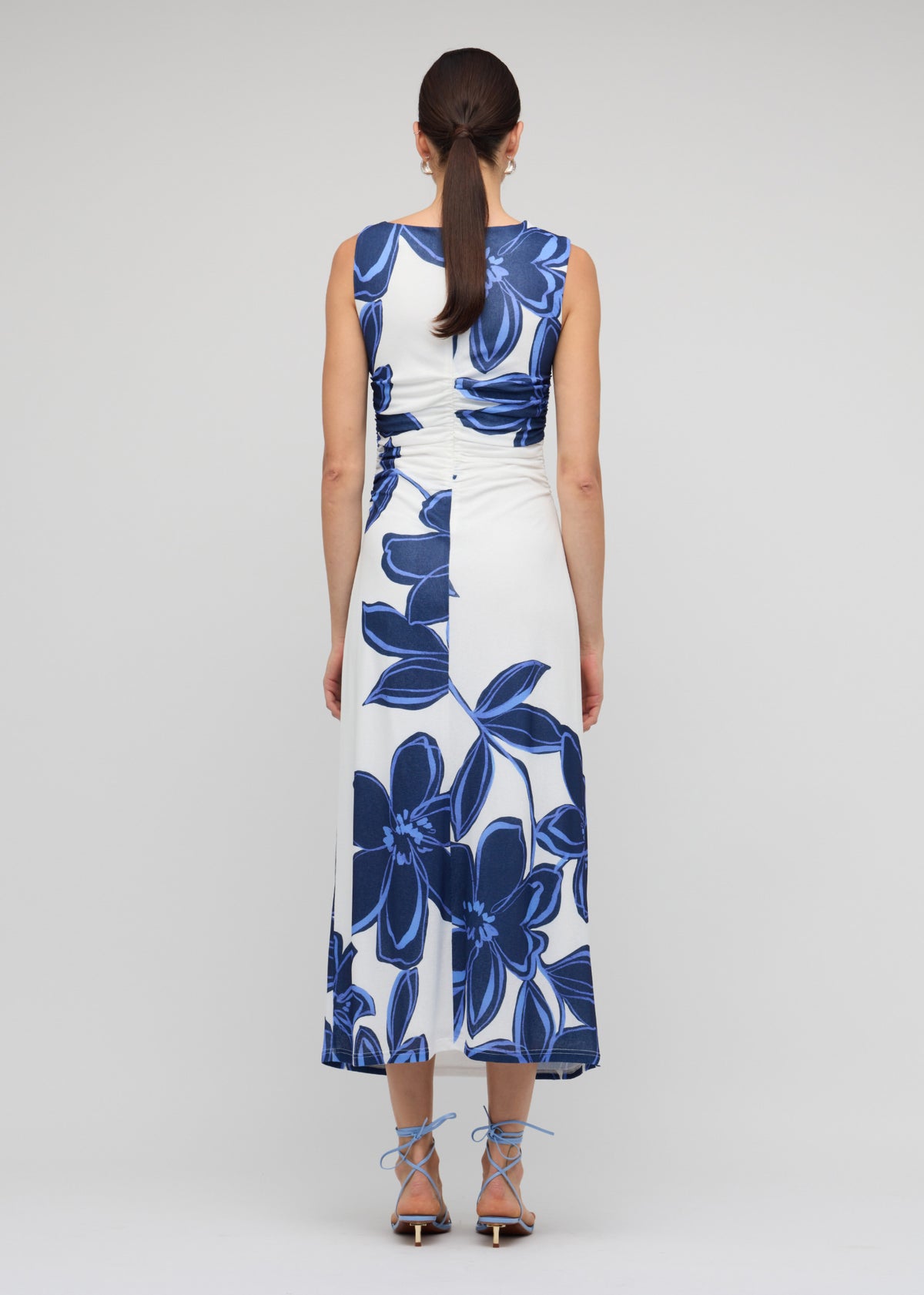Back view of the Blue and White Floral Mesh Midi Dress with a blue oversized floral print and a midi length, body-skimming silhouette.