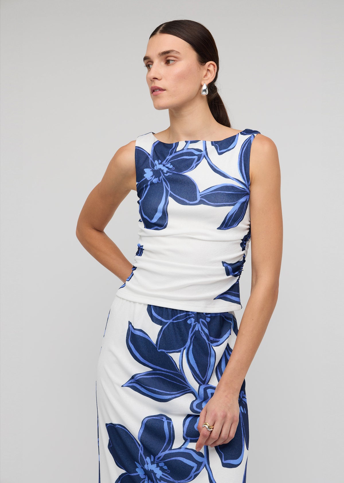 Close-up of the Blue and White Floral Mesh Top, showing a sleeveless tank silhouette and a blue floral mesh print.