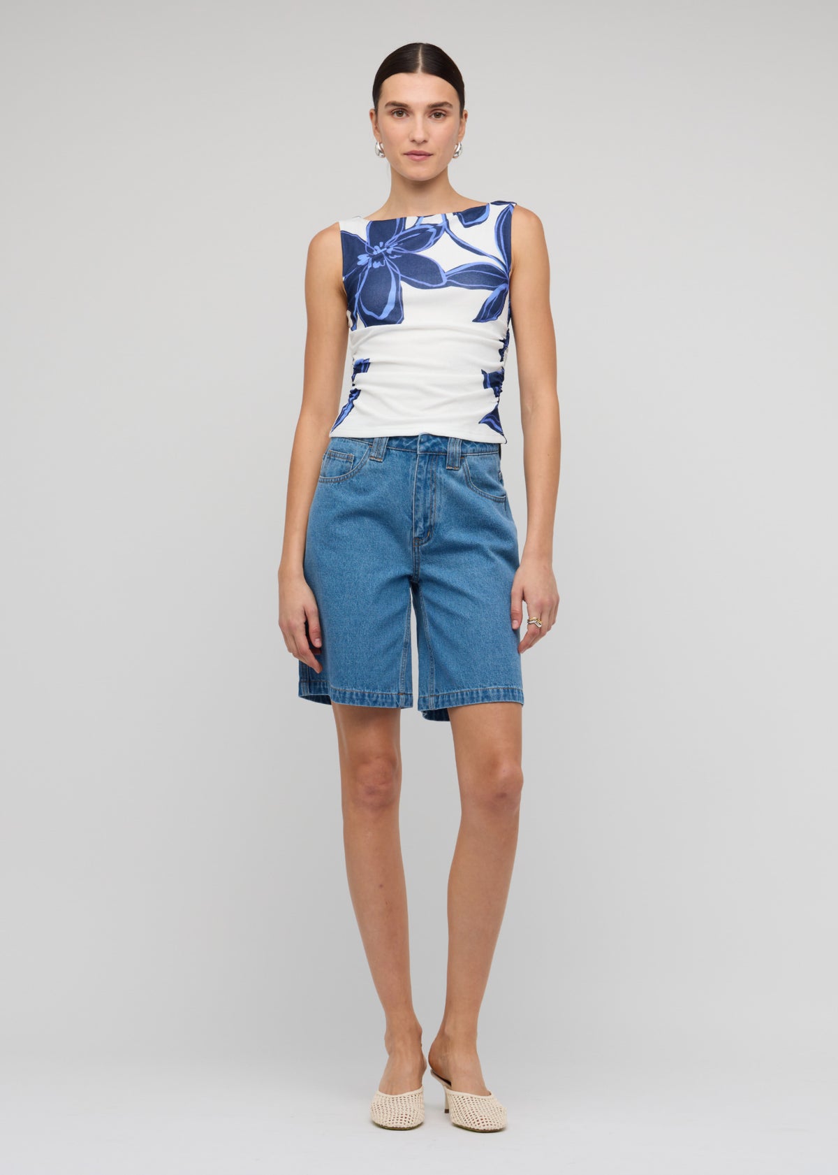 Model wearing Blue and White Floral Mesh Top with a stretch fit, fully lined and a side ruching detail.