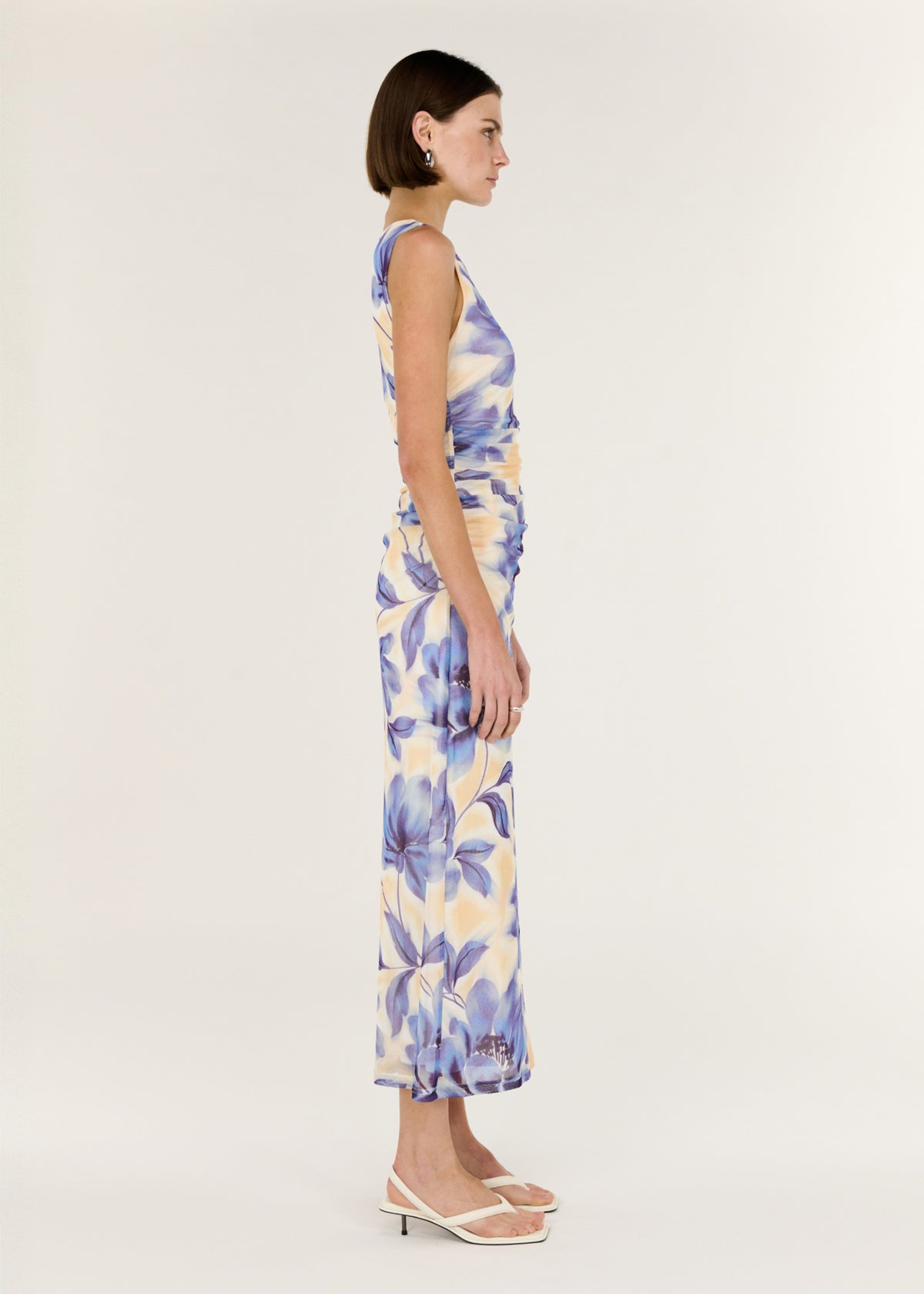 Side view of the Blue Blurred Floral Mesh Midi Dress, showing a subtle ruching through the waist and a body-skimming silhouette.