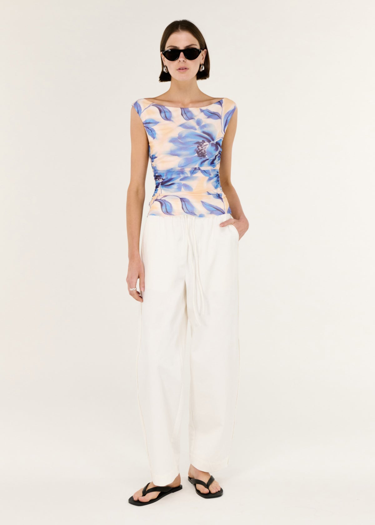 Model wearing Blue Blurred Floral Mesh Top, showing a body-skimming silhouette and a sleeveless cut.