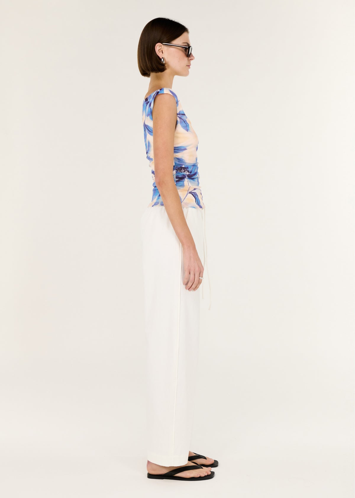 Side view of the Blue Blurred Floral Mesh Top, showing a stretch fabrication and a soft blurred floral print.
