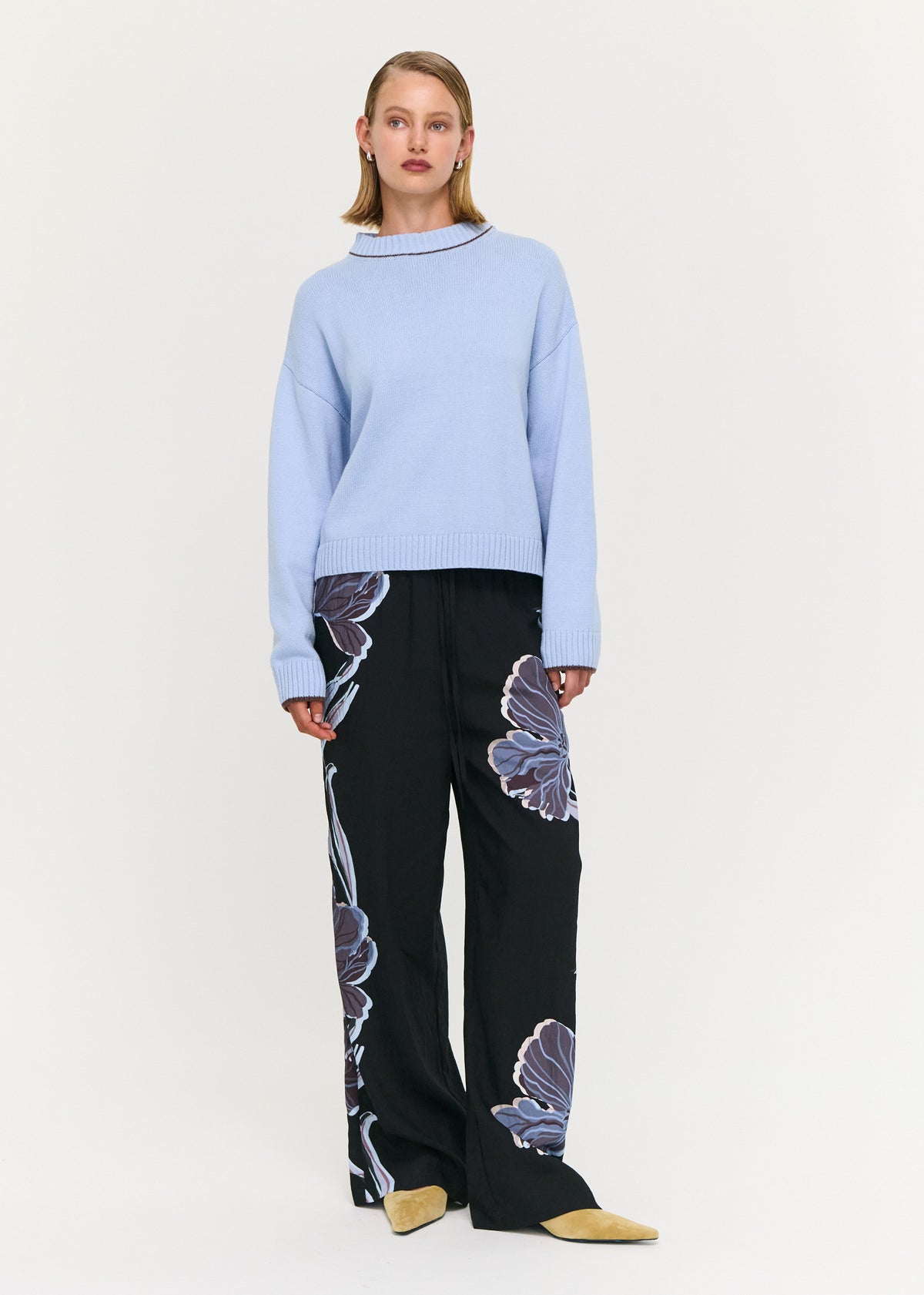 Model wearing Blue Cotton Blend Contrast Seam Jumper with a crew neckline with contrast trim and long sleeves with ribbed cuffs.