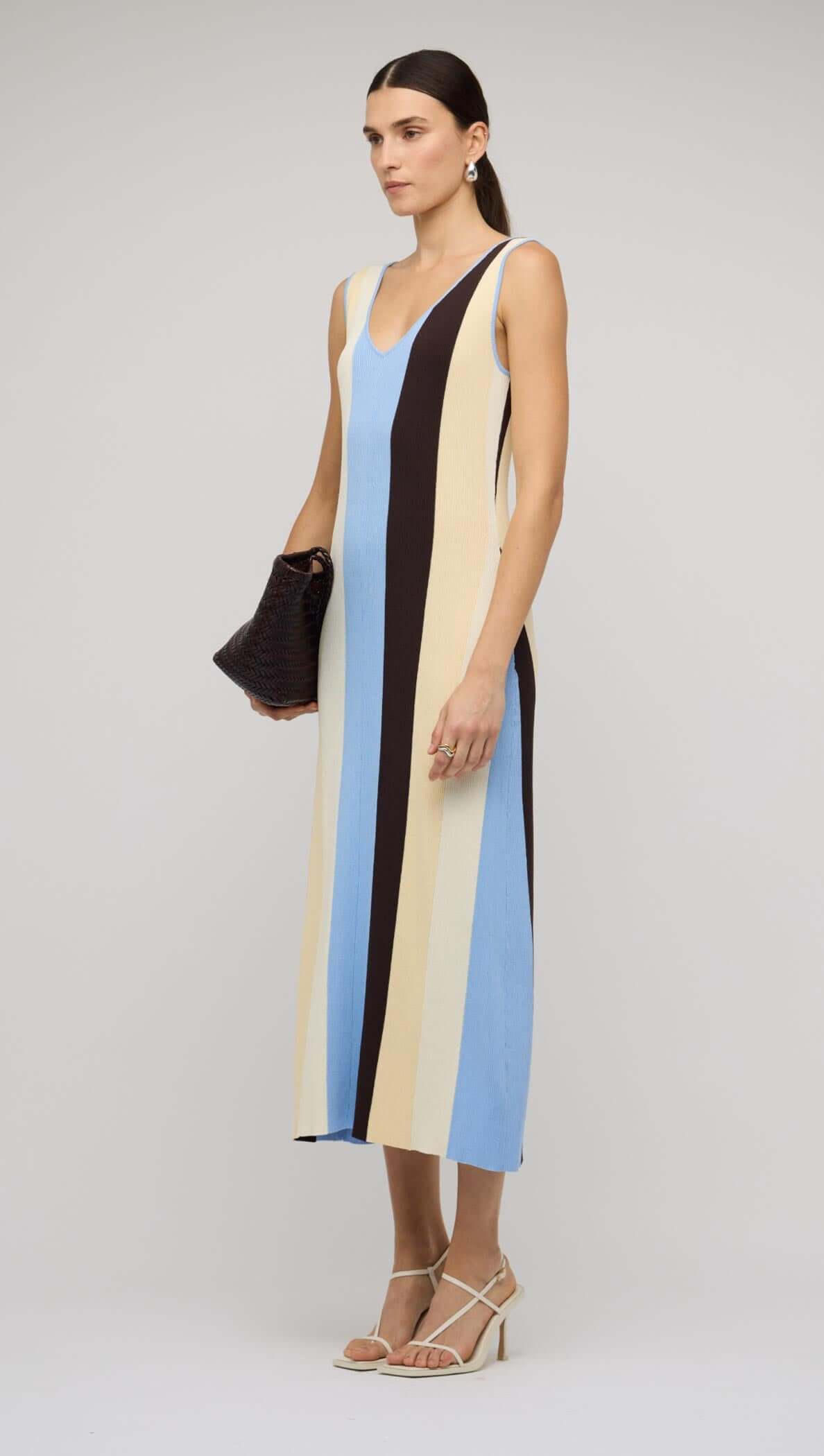 Model wearing a Blue & Cream Stripe Knit Midi Dress by Staple the Label, showcasing bold vertical stripes.
