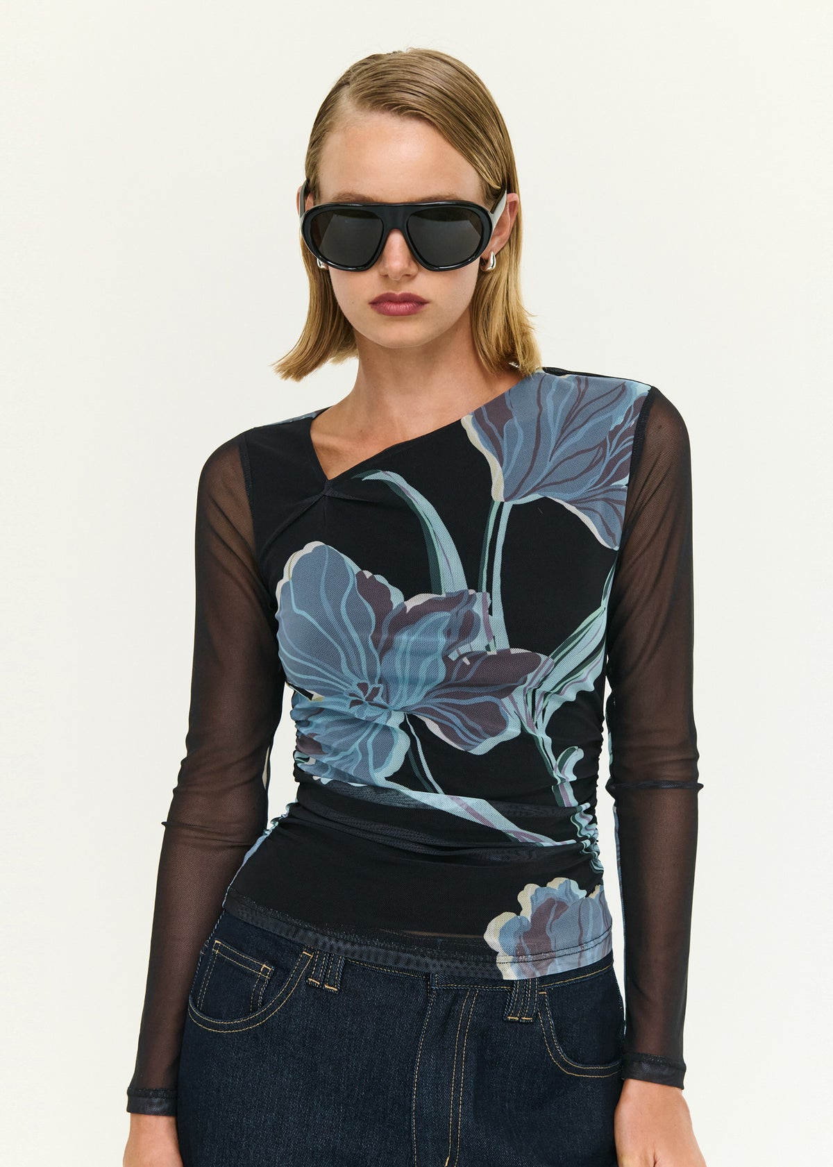 Close-up of the Blue Floral Asymmetric Neck Mesh Top, showing an asymmetrical neckline detail and long sheer sleeves.