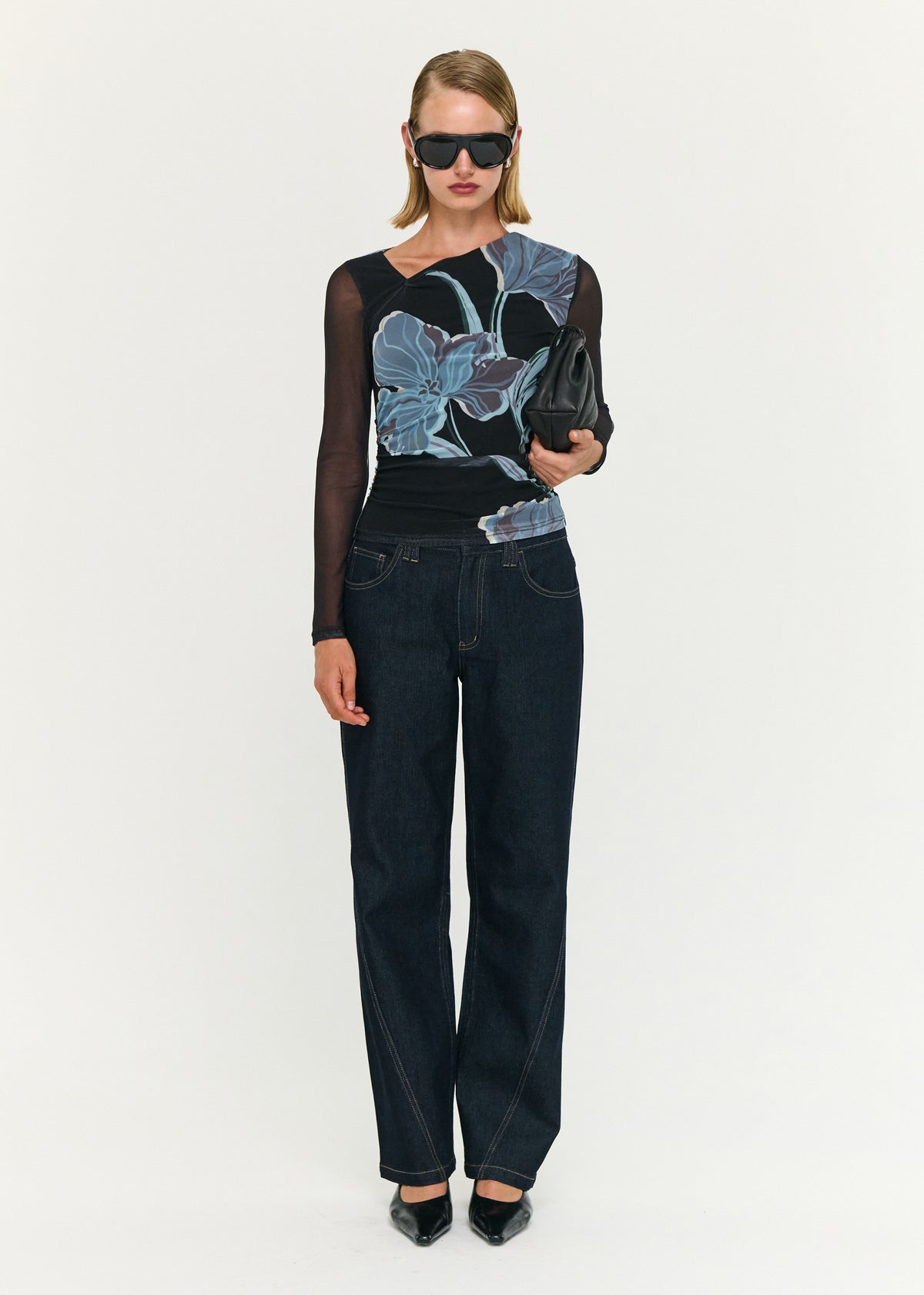 Model wearing Blue Floral Asymmetric Neck Mesh Top with an asymmetrical neckline detail and long sheer sleeves.