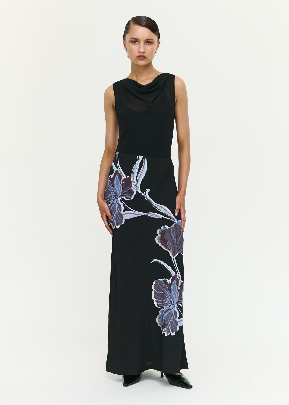 Model wearing Blue Floral Bias Cut Combo Midi Dress with a lightweight woven fabrication and a sleeveless cut.