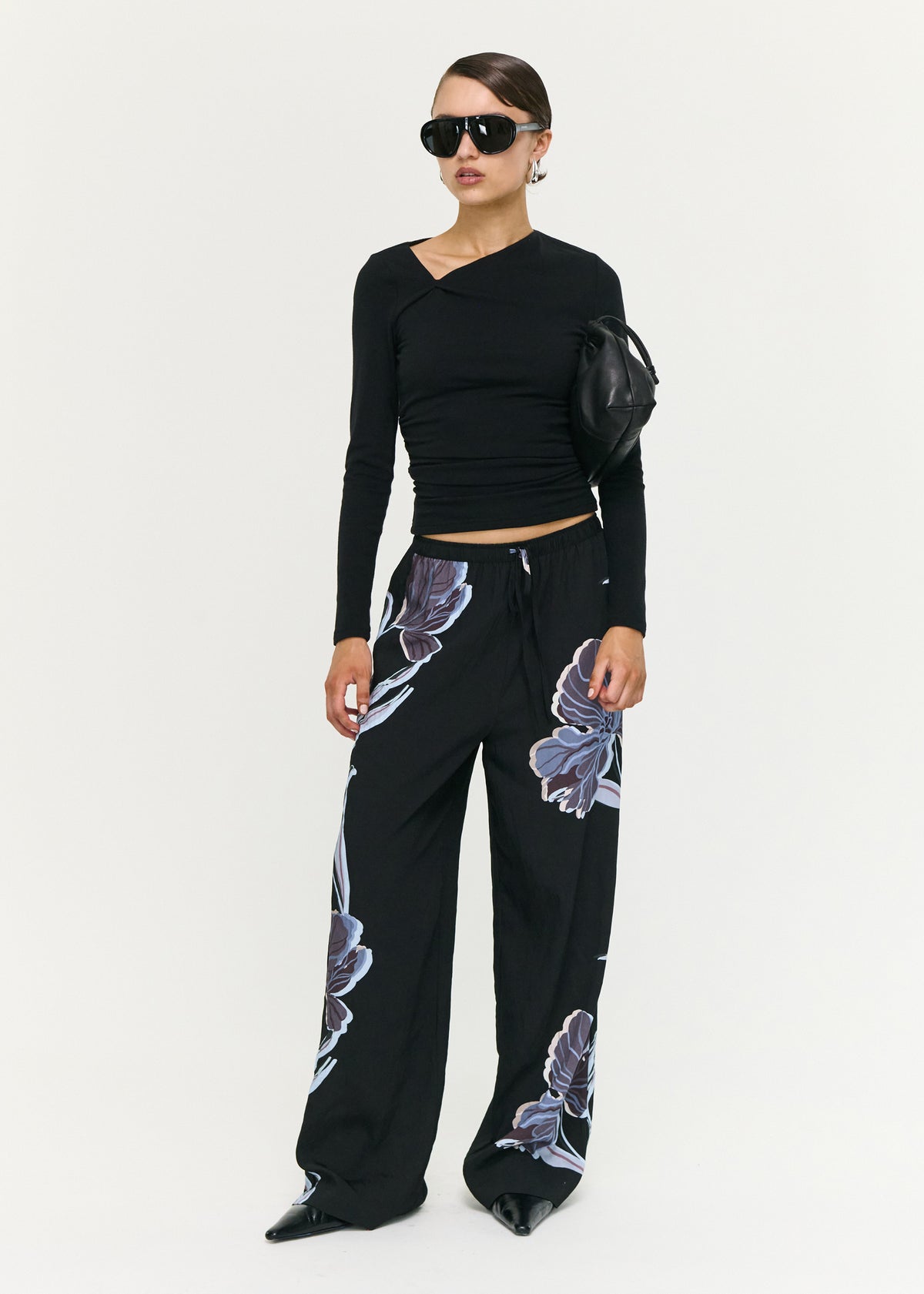 Model wearing Blue Floral Relaxed Drawstring Pant with a lightweight woven fabrication and a relaxed wide leg silhouette.