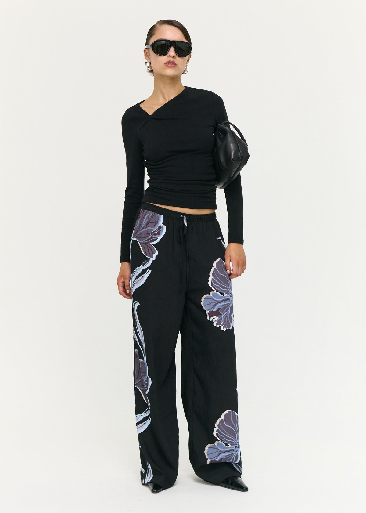 Model wearing Blue Floral Relaxed Drawstring Pant, showing an elasticated waistband with drawstring and side pockets.