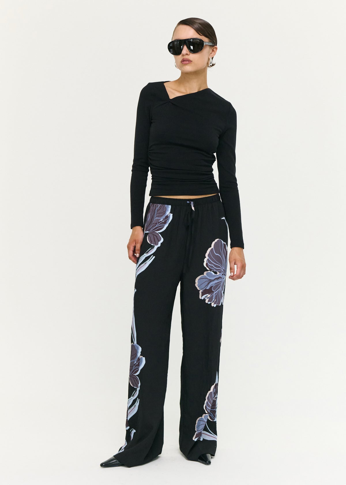 Model wearing Blue Floral Relaxed Drawstring Pant with a relaxed wide leg silhouette and a lightweight woven fabrication.