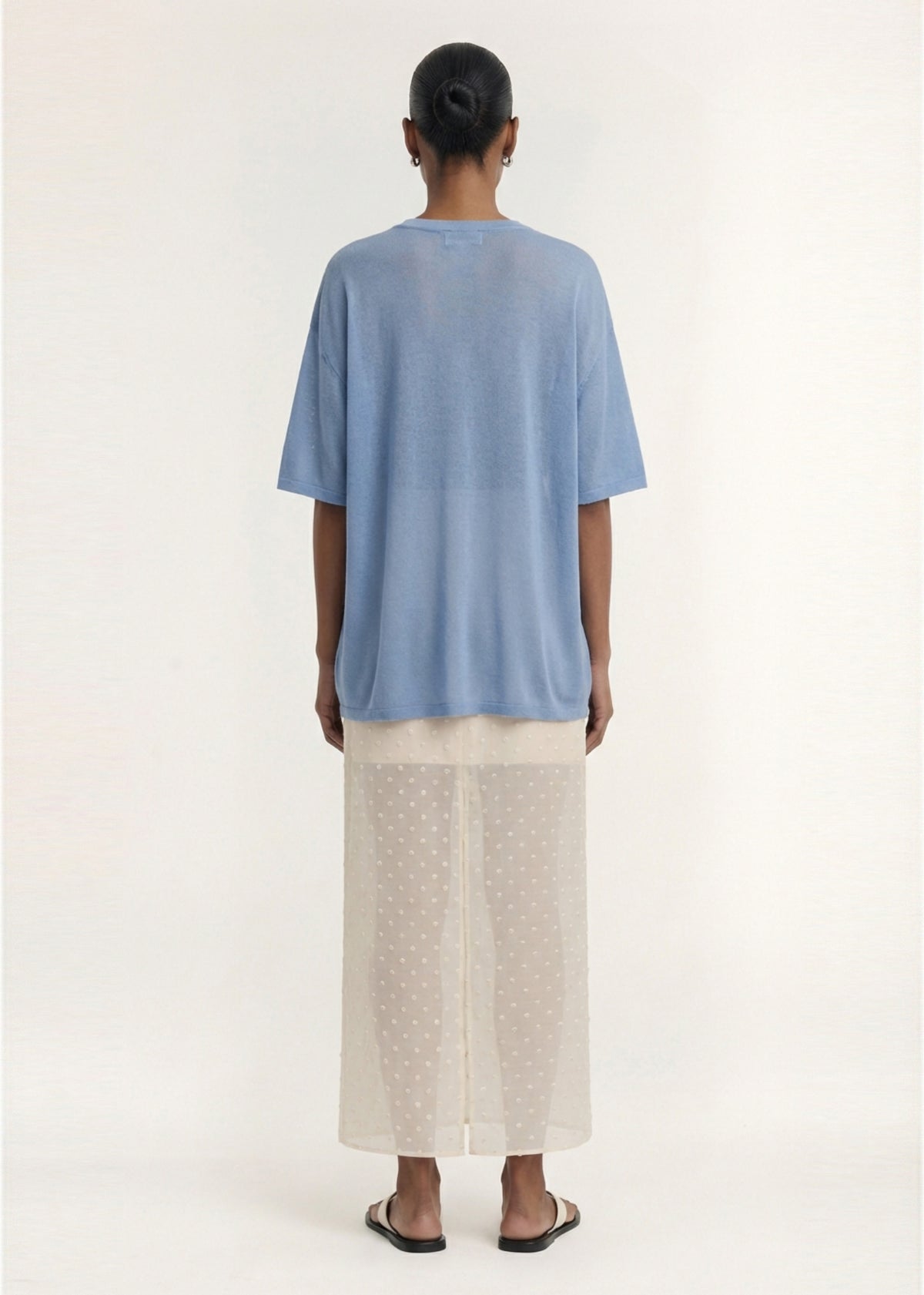 Back view of the Blue Round Neck Oversized Knit Tee with a lightweight knit fabrication and a round neckline.