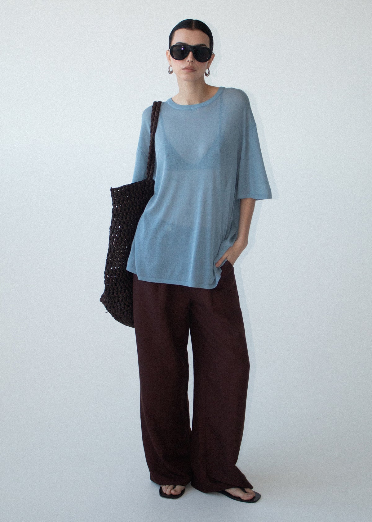Model wearing Blue Round Neck Oversized Knit Tee with an oversized silhouette and a relaxed fit.