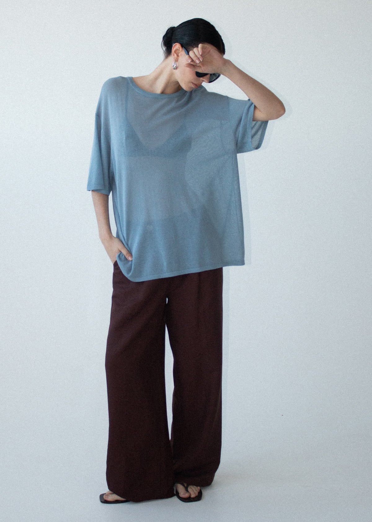 Model wearing Blue Round Neck Oversized Knit Tee, showing a lightweight knit fabrication and a round neckline.