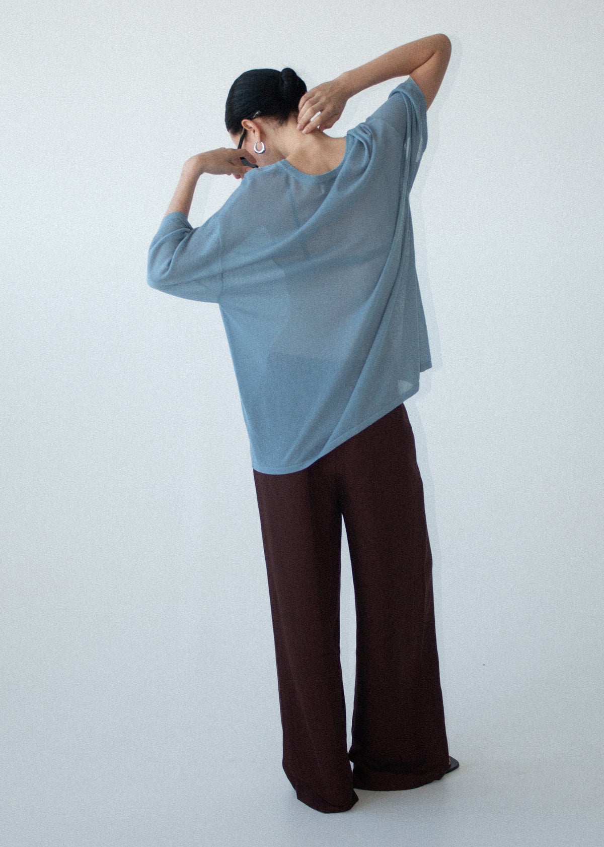 Model wearing Blue Round Neck Oversized Knit Tee with a relaxed fit and an oversized silhouette.
