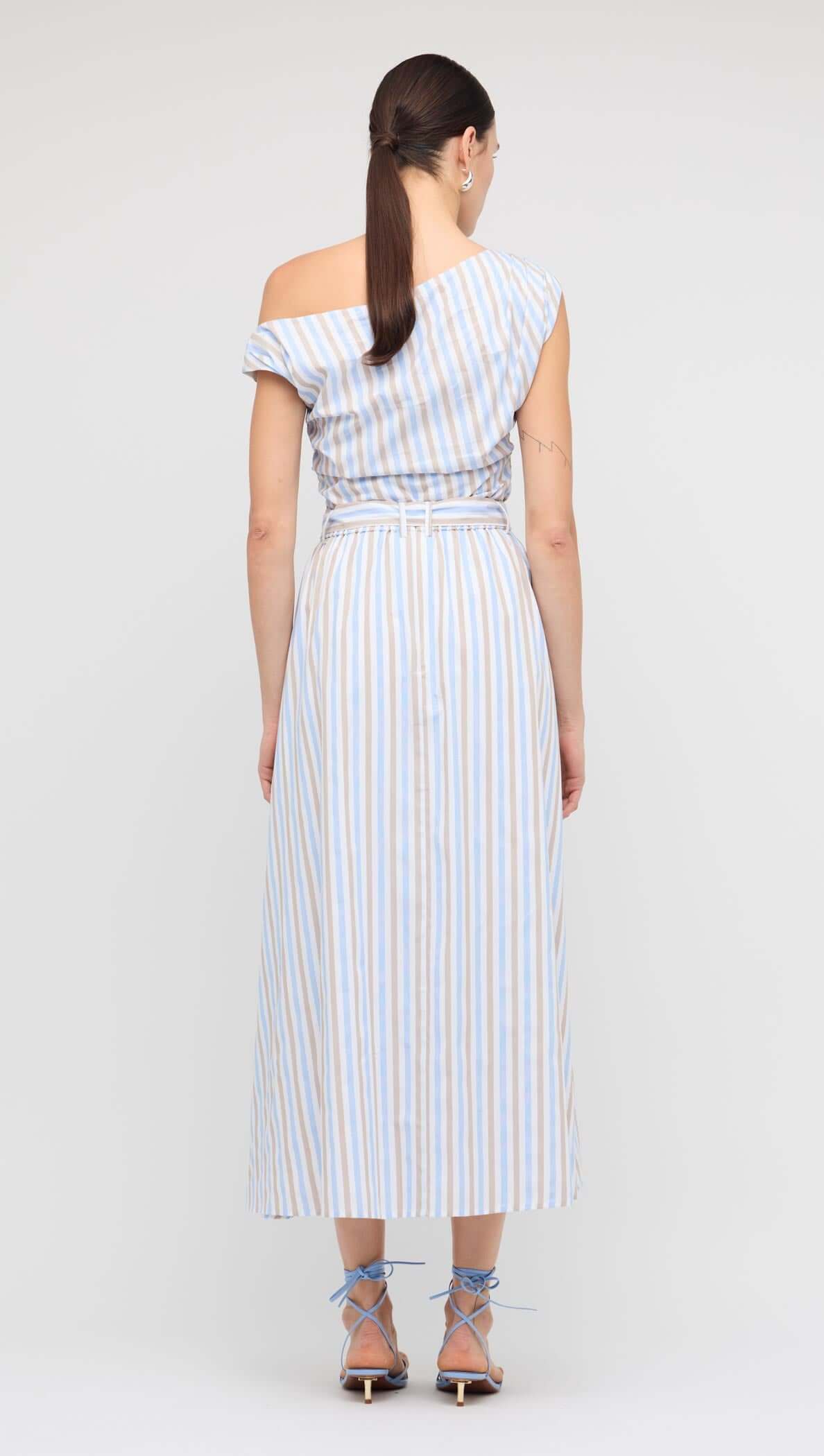 Back view of a woman wearing a Blue Stripe Cotton A-Line Maxi Skirt with an off-shoulder top.