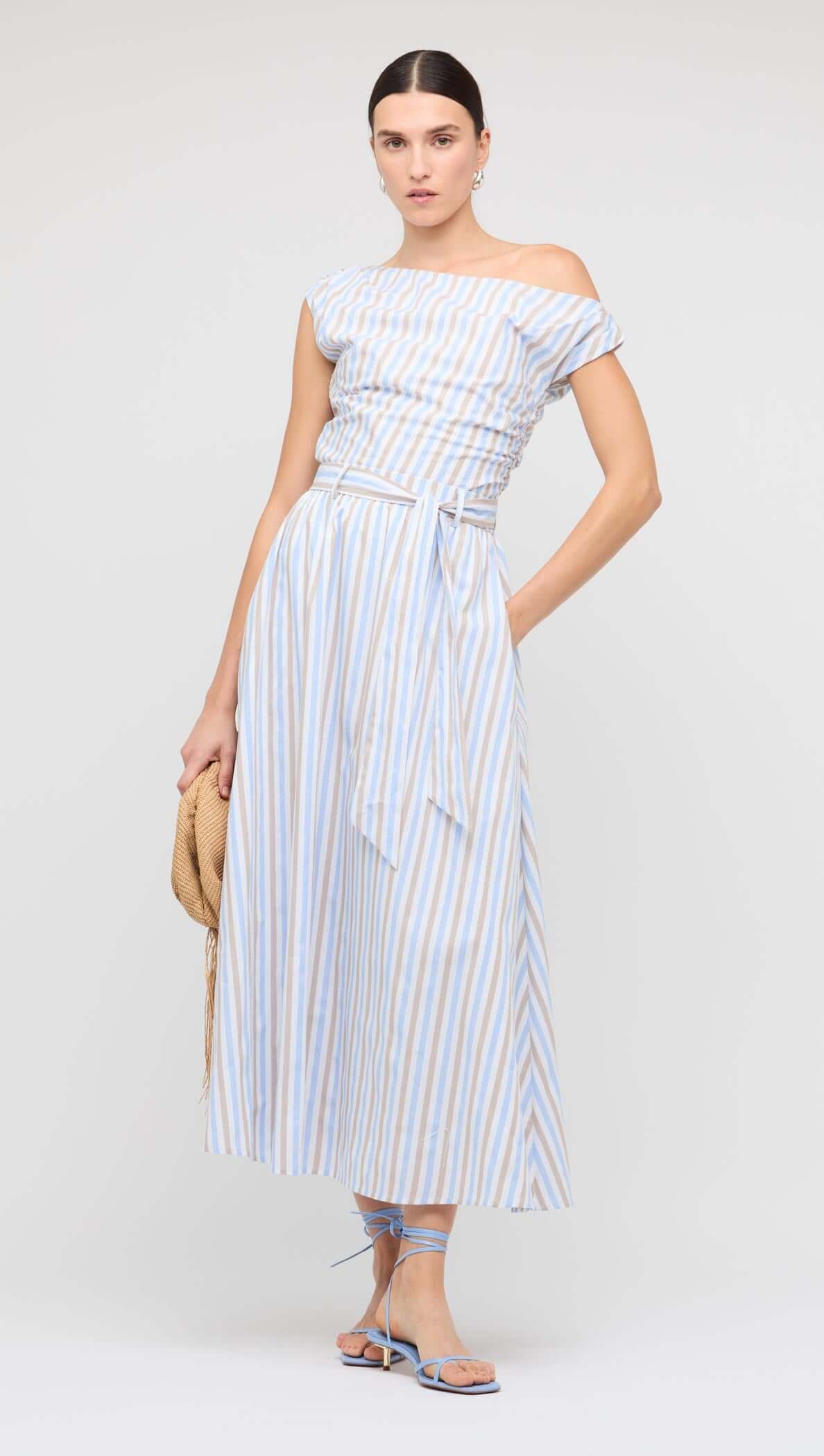 Model wearing a Blue Stripe Cotton A-Line Maxi Skirt paired with a matching striped shirt on a blue background.