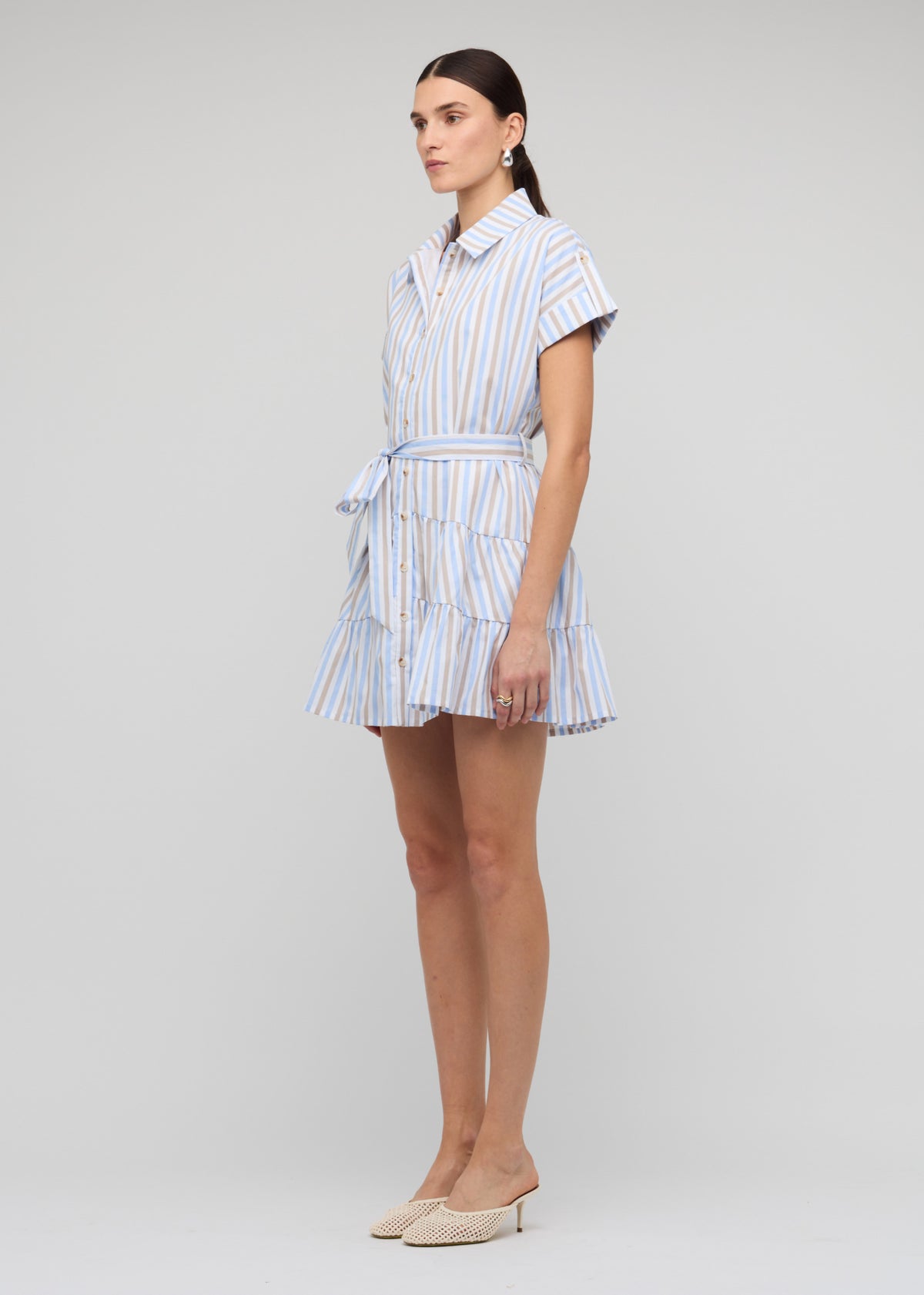 Model wearing Blue Stripe Cotton Mini Shirt Dress with an adjustable waist tie and short cuff sleeves.