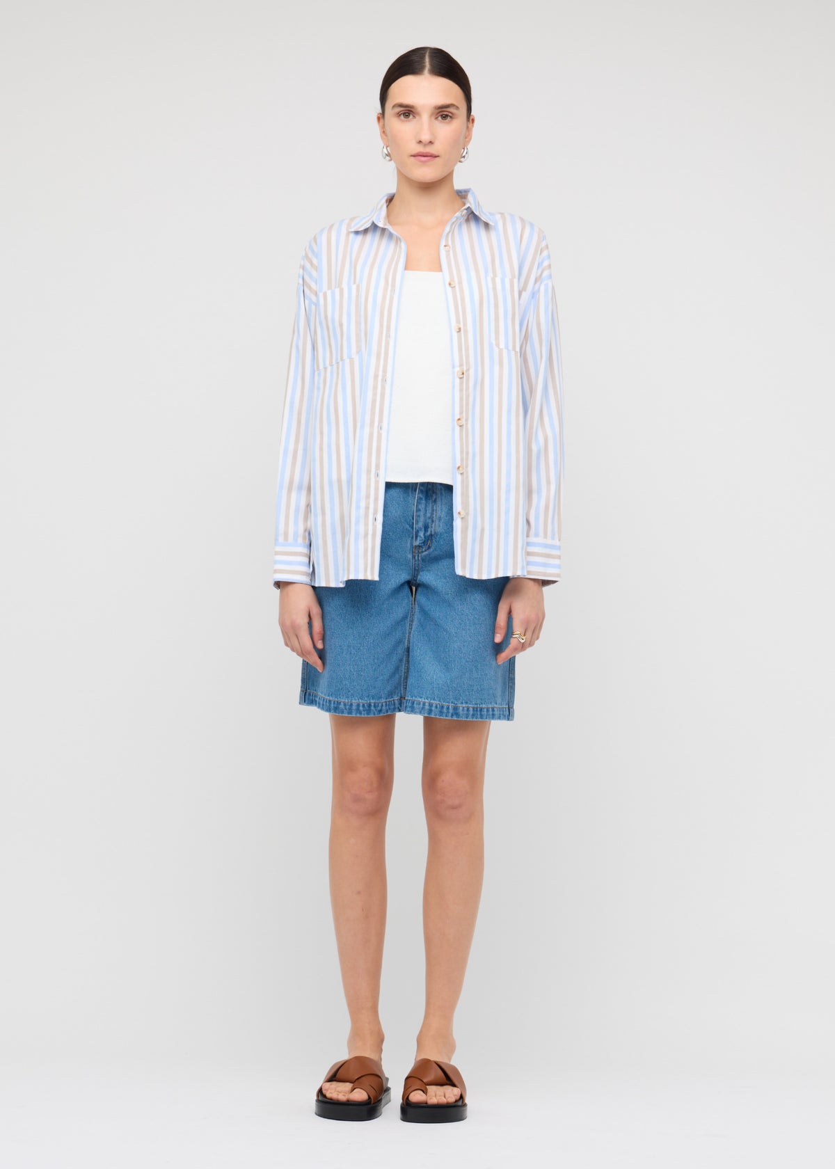 Model wearing Blue Stripe Cotton Oversize Shirt with a relaxed oversized fit.