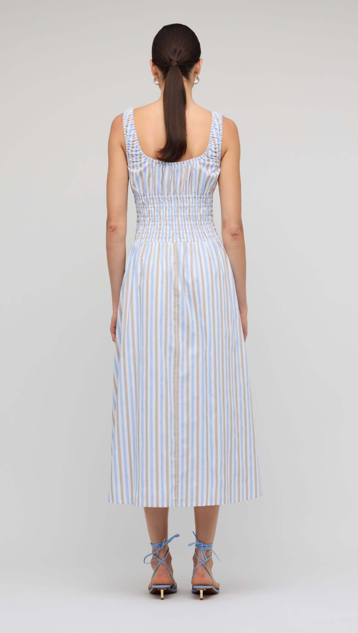 Back view of the Blue Stripe Cotton Shirred Midi Dress showcasing the shirred bodice and relaxed A-line skirt.