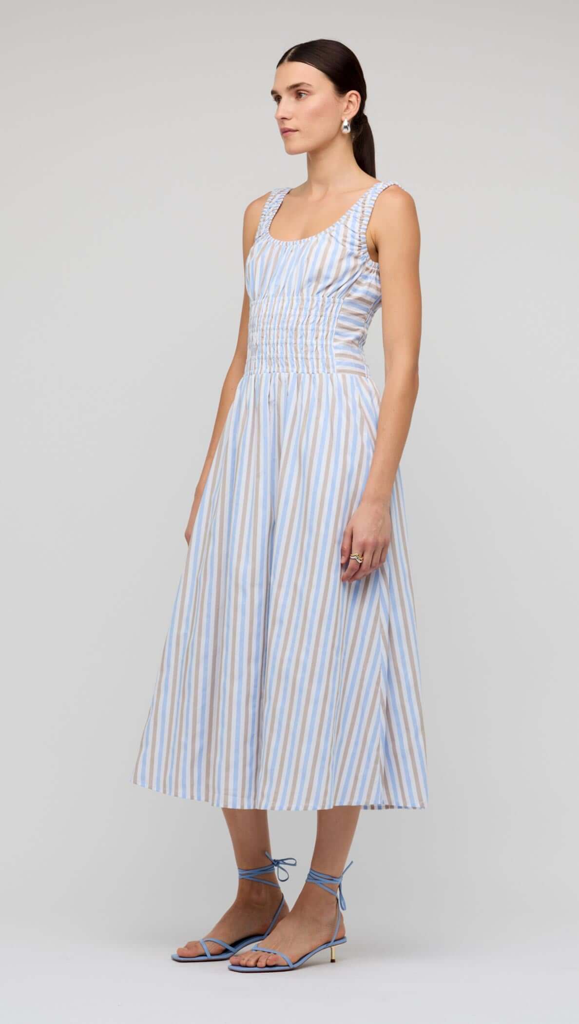 Blue Stripe Cotton Shirred Midi Dress shown on model, featuring a shirred bodice and relaxed A-line skirt.