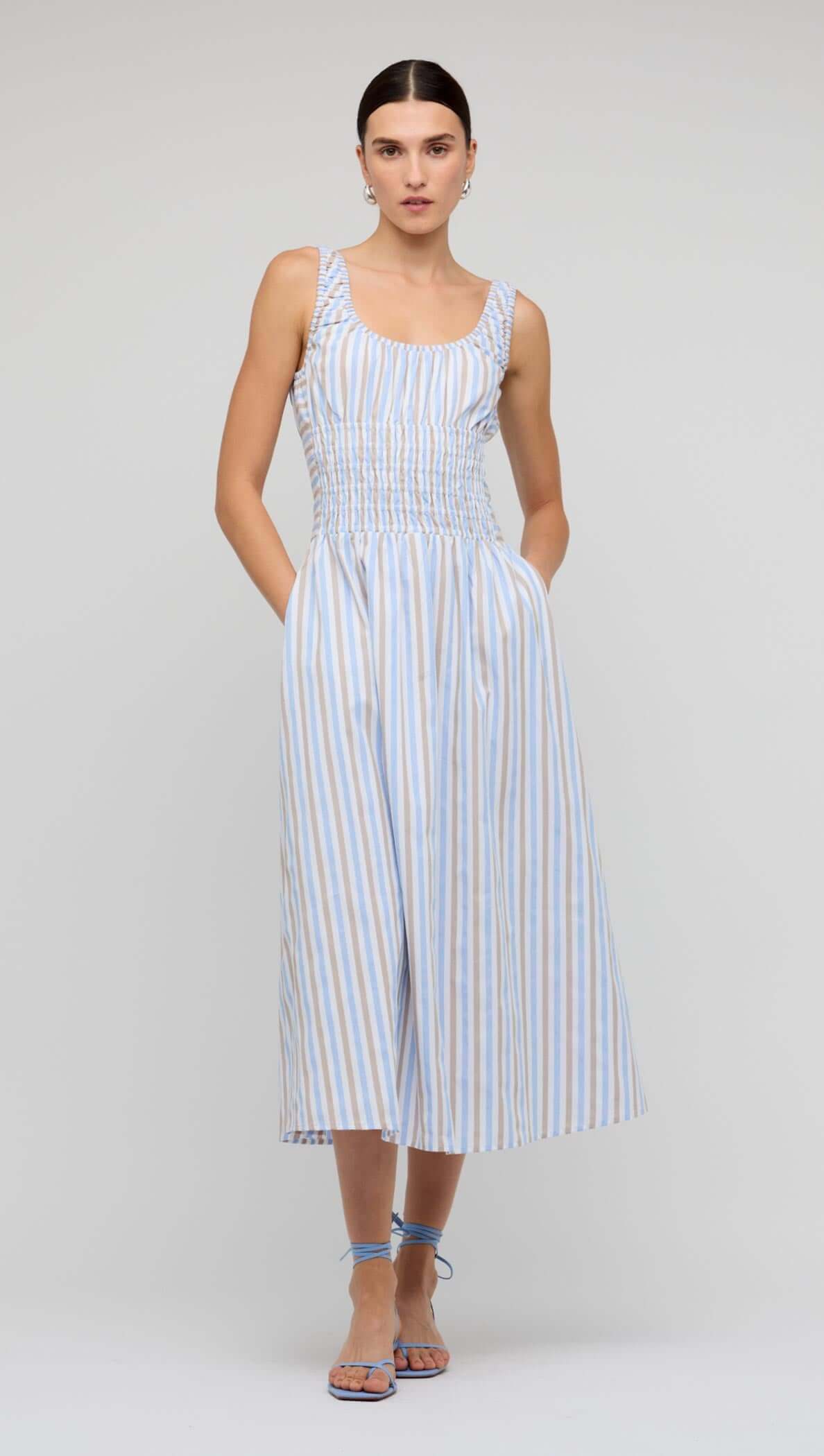 Blue Stripe Cotton Shirred Midi Dress worn by a model, showcasing its relaxed A-line skirt and flattering bodice.