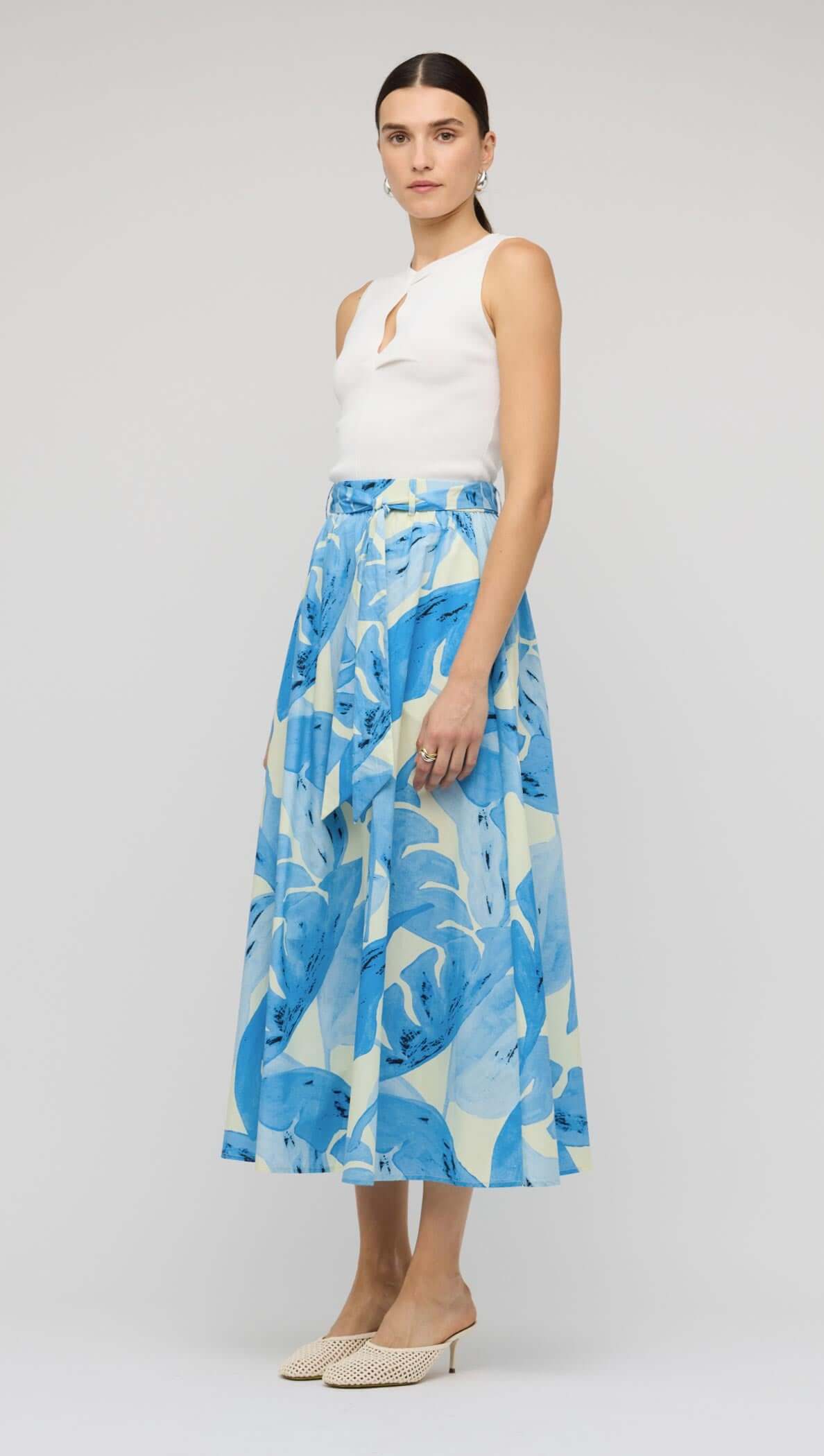 Blue & White Floral Cotton A-Line Maxi Skirt worn by a model, featuring a high waist and self-tie belt.