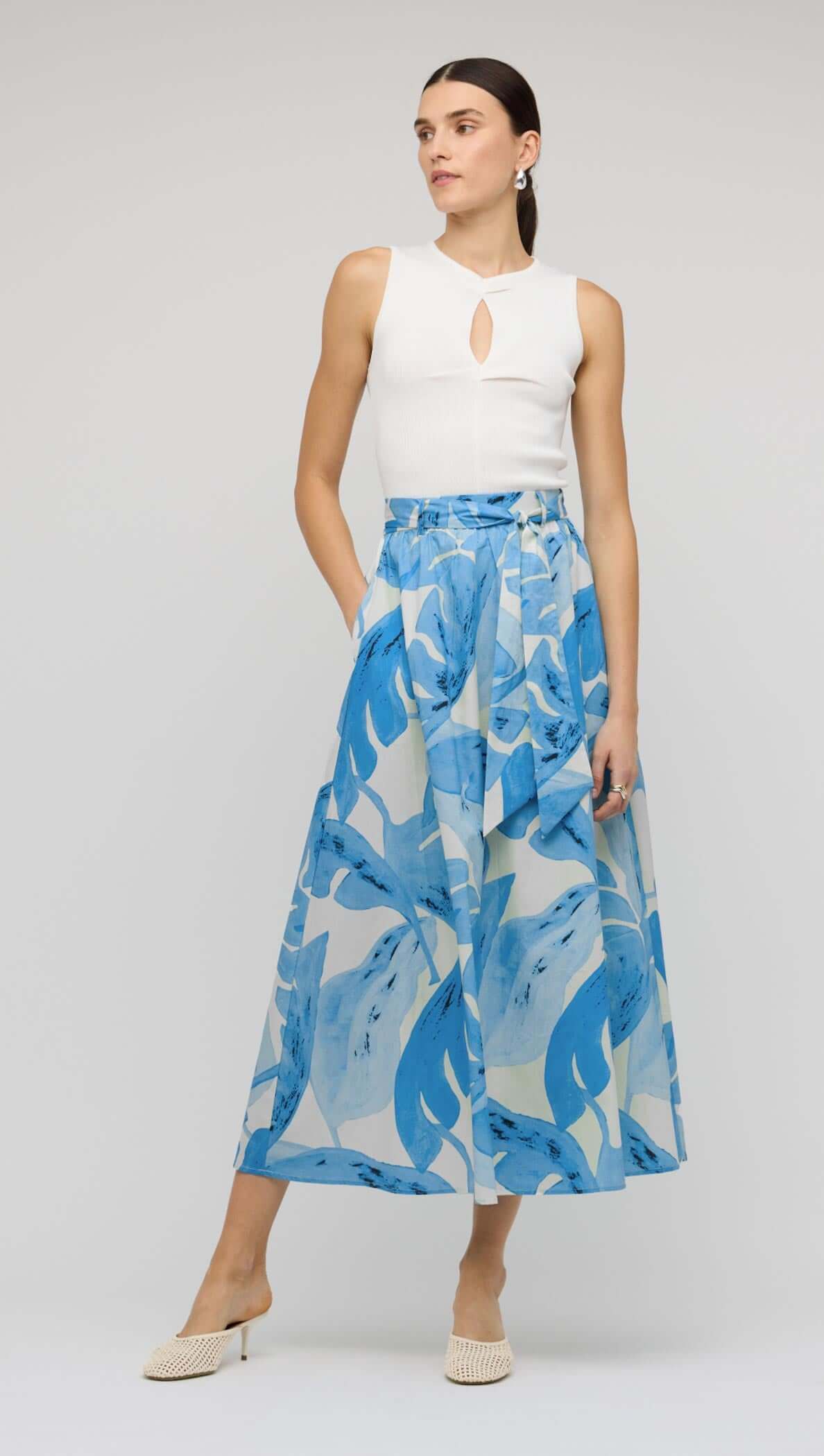 Blue & White Floral Cotton A-Line Maxi Skirt worn by a model, featuring a high waist and self-tie belt.