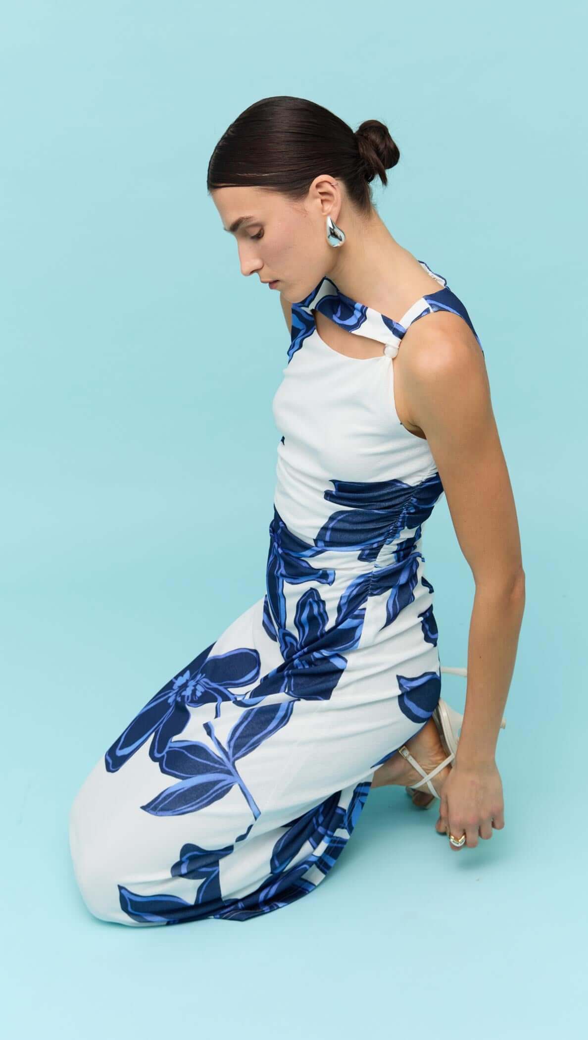 Model wearing a Blue & White Floral Mesh Midi Dress by Staple the Label against a light blue background.