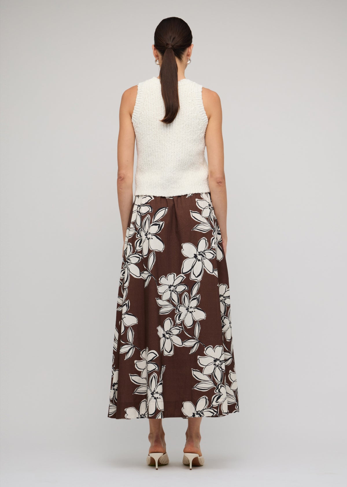 Back view of the Brown and White Cotton Floral A-Line Maxi Skirt with a chocolate brown with white floral print.