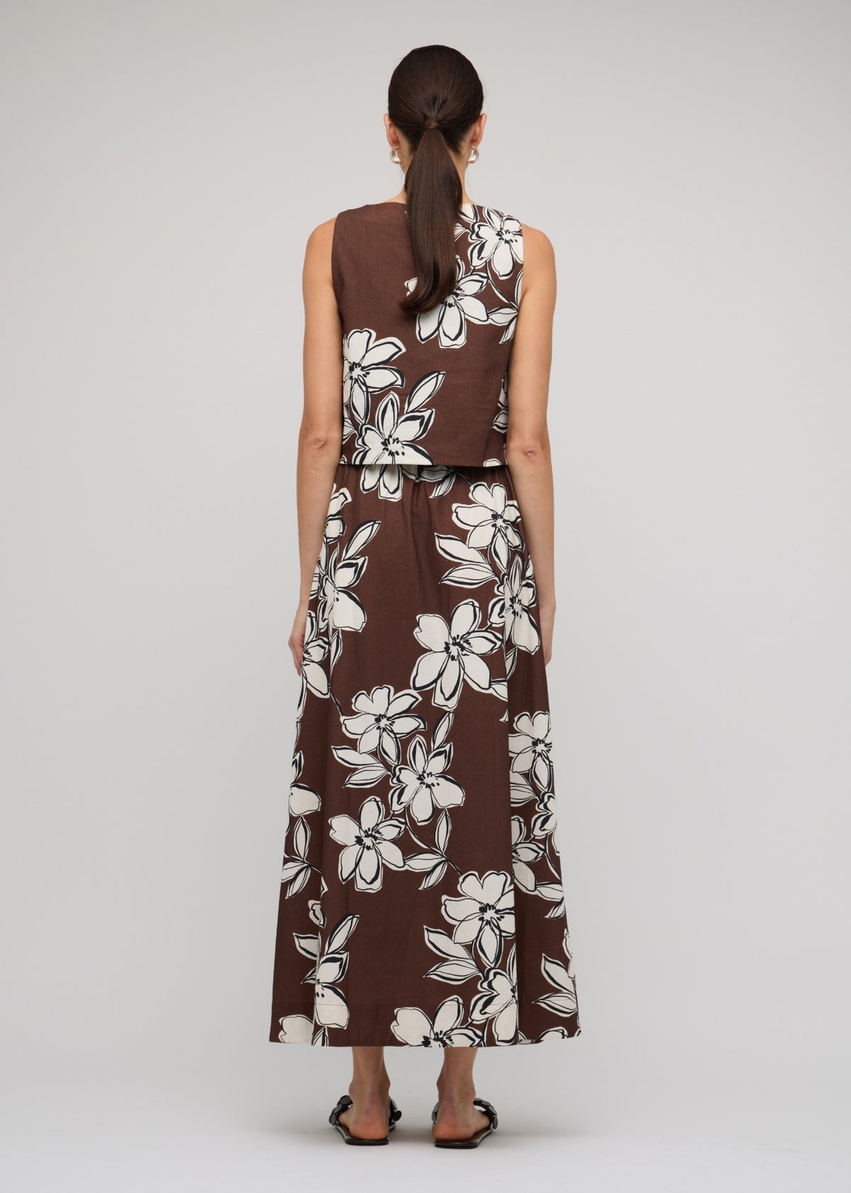 Back view of the Brown and White Cotton Floral A-Line Maxi Skirt, showing a chocolate brown with white floral print.