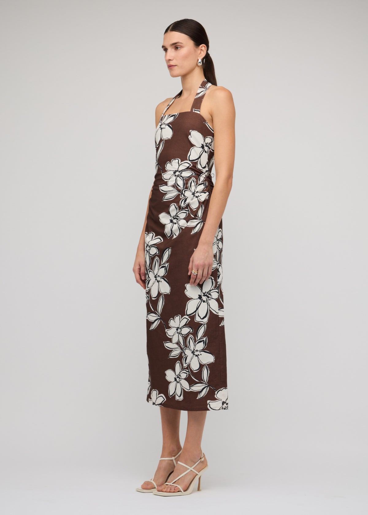 Model wearing Brown and White Cotton Floral Halter-Neck Midi Dress, showing a chocolate brown with white floral print.