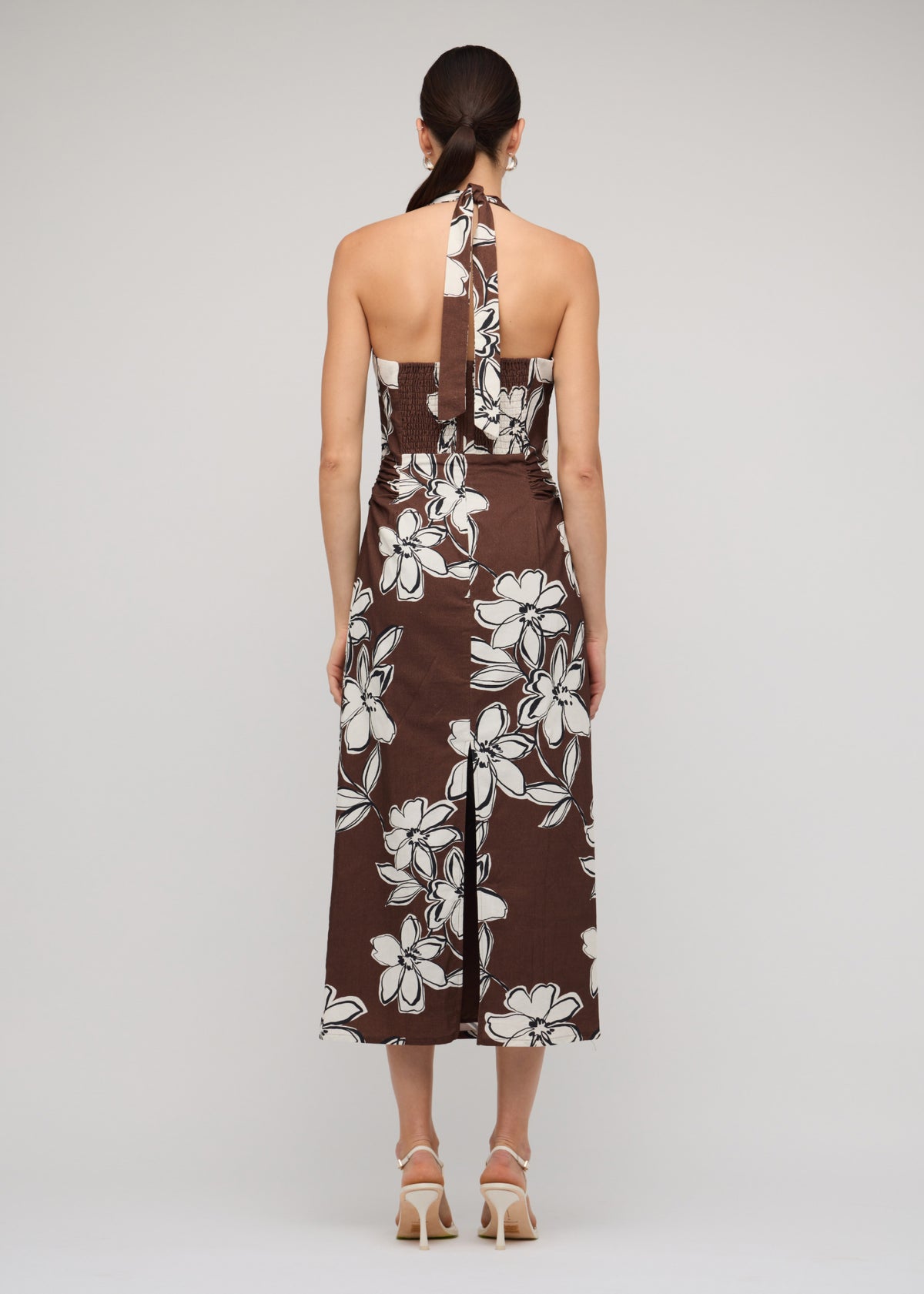 Back view of the Brown and White Cotton Floral Halter-Neck Midi Dress with a chocolate brown with white floral print.
