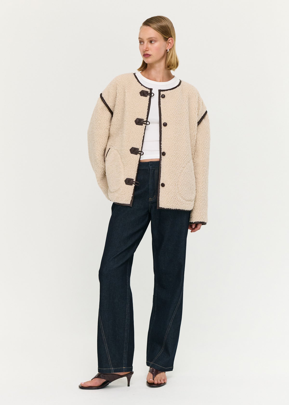 Model wearing Brown Contrast Trim Duffle Coat in Teddy with front patch pockets and a hip length.
