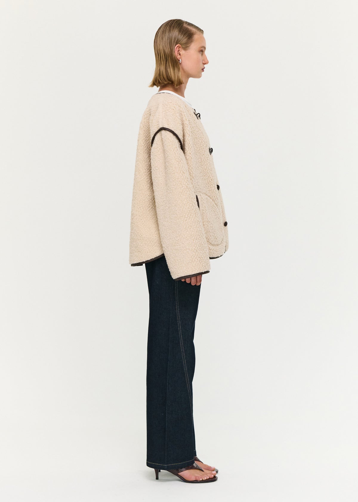 Side view of the Brown Contrast Trim Duffle Coat in Teddy, showing a soft teddy fabrication and a relaxed fit.