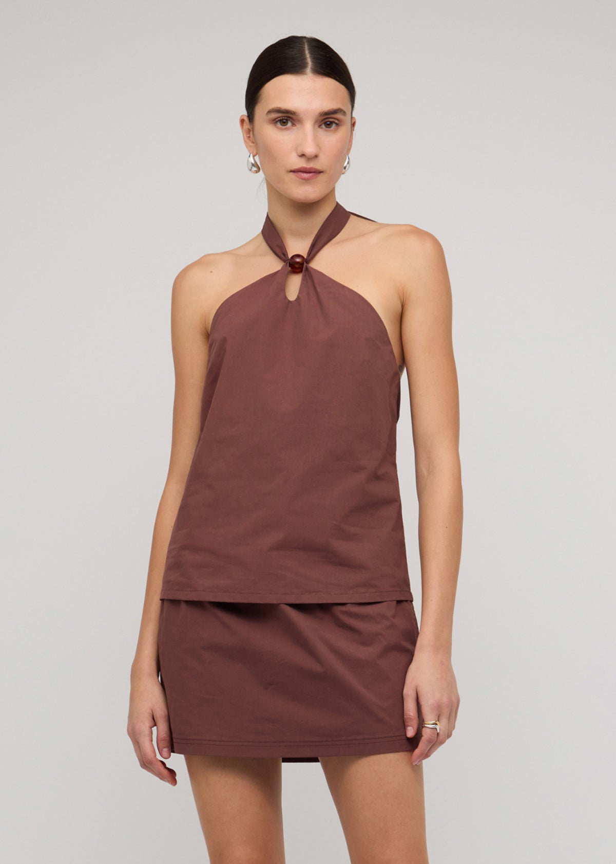 Model wearing Brown Cotton Bead Halter-Neck Top with a 100% Cotton and a halter neck with ring detail.