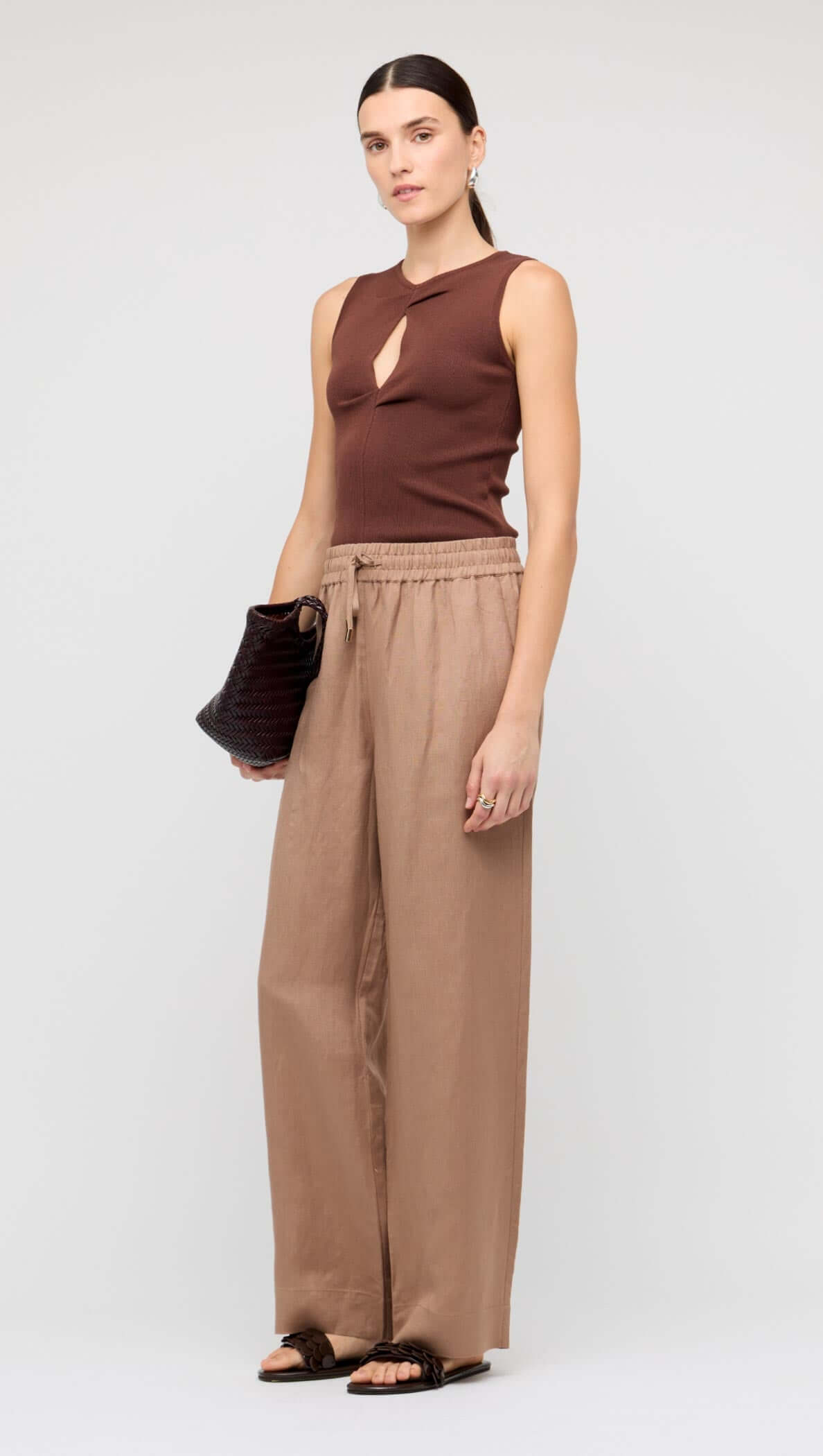 Brown Cut-Out Sleeveless Knit Top featuring a front cutout, sleeveless design, and ribbed texture.