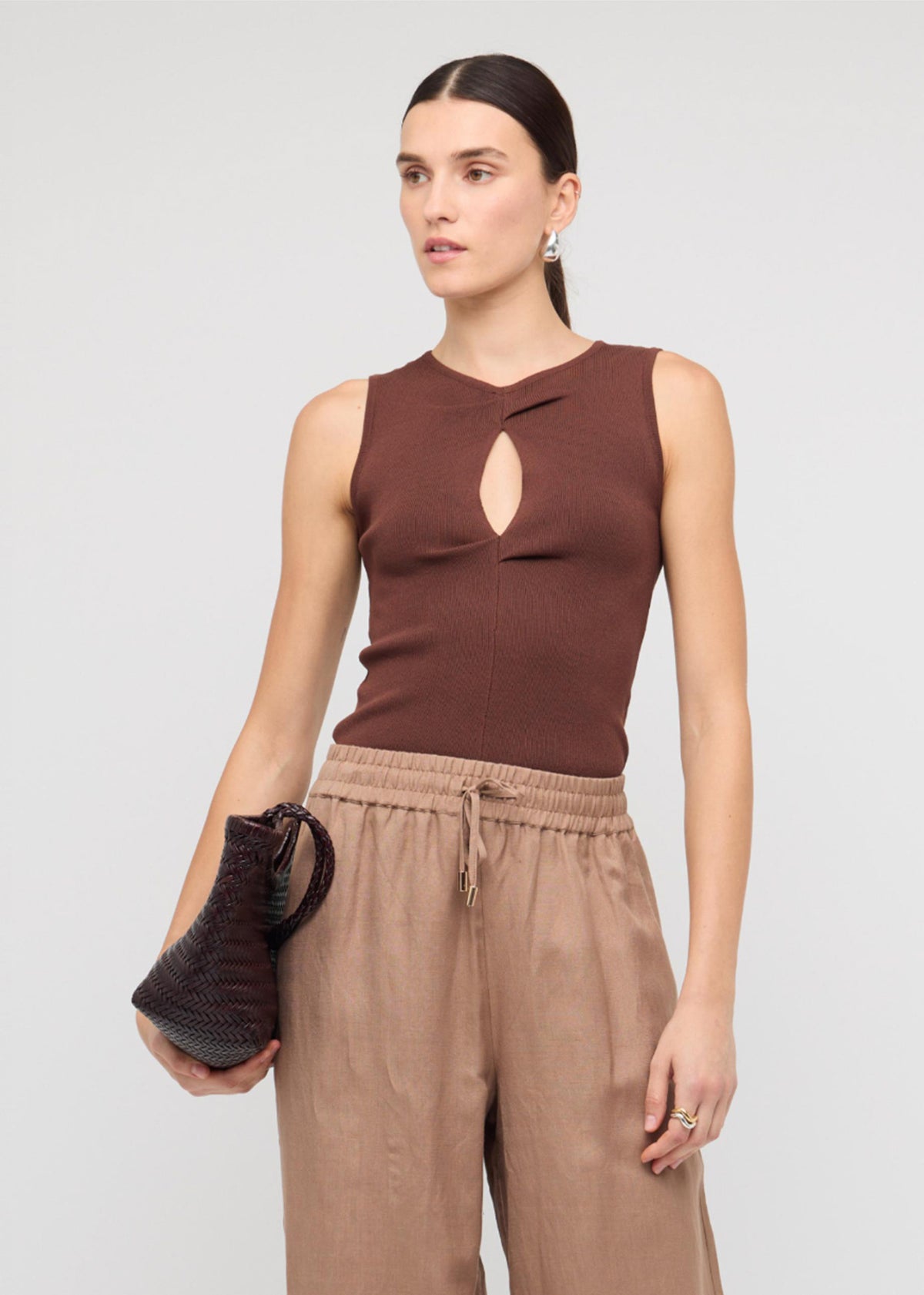 Close-up of the Brown Cut-Out Sleeveless Knit Top, showing a sleeveless cut and a ribbed stretch fabrication.