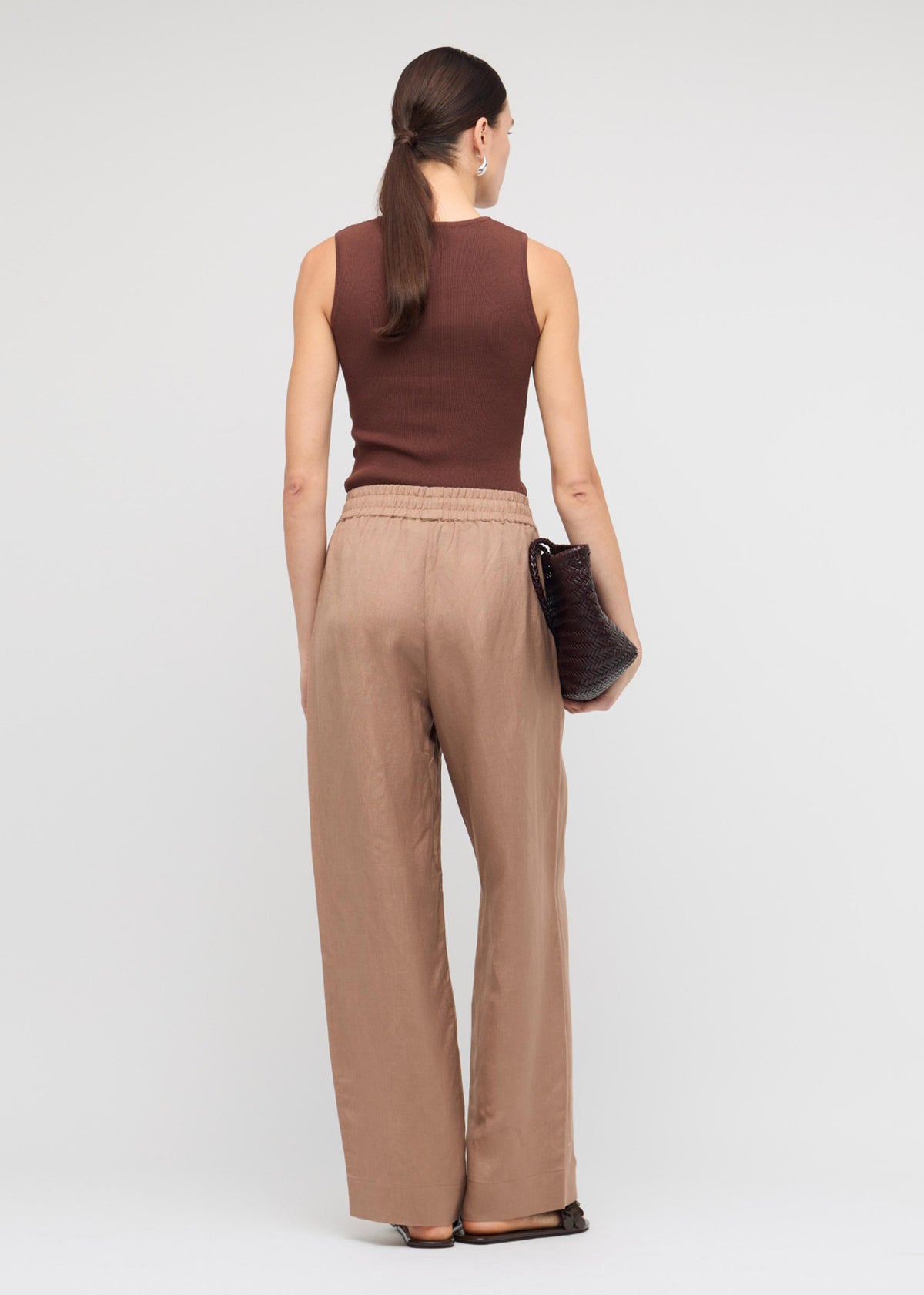 Back view of the Brown Cut-Out Sleeveless Knit Top with a sleeveless cut and a ribbed stretch fabrication.
