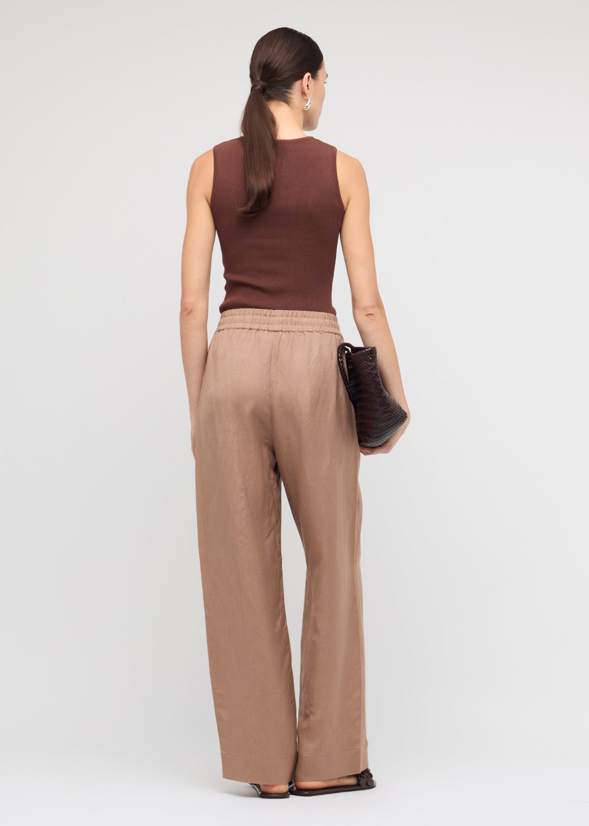 Back view of the Brown Cut-Out Sleeveless Knit Top, showing a sleeveless cut and a ribbed stretch fabrication.