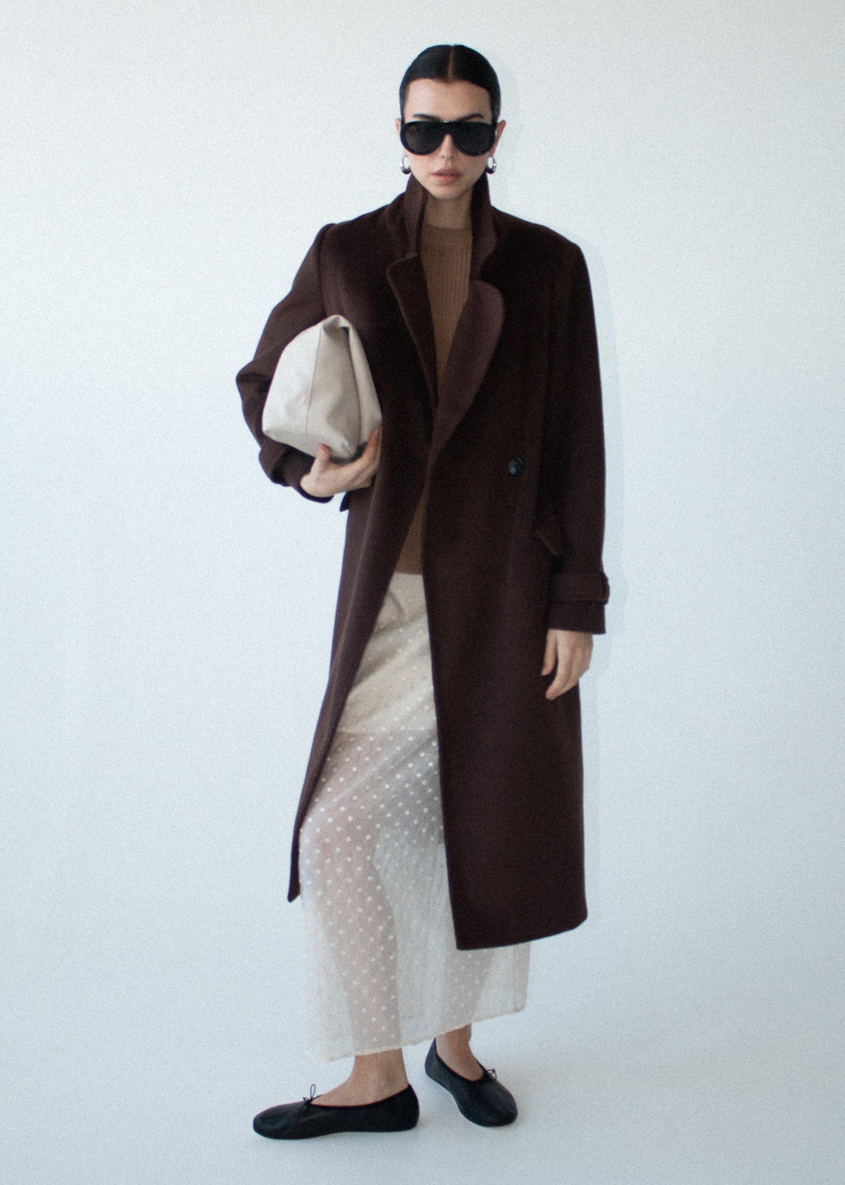 Model wearing Brown Double-Breasted Longline Coat, showing a soft brushed woven fabrication and a double-breasted front closure.
