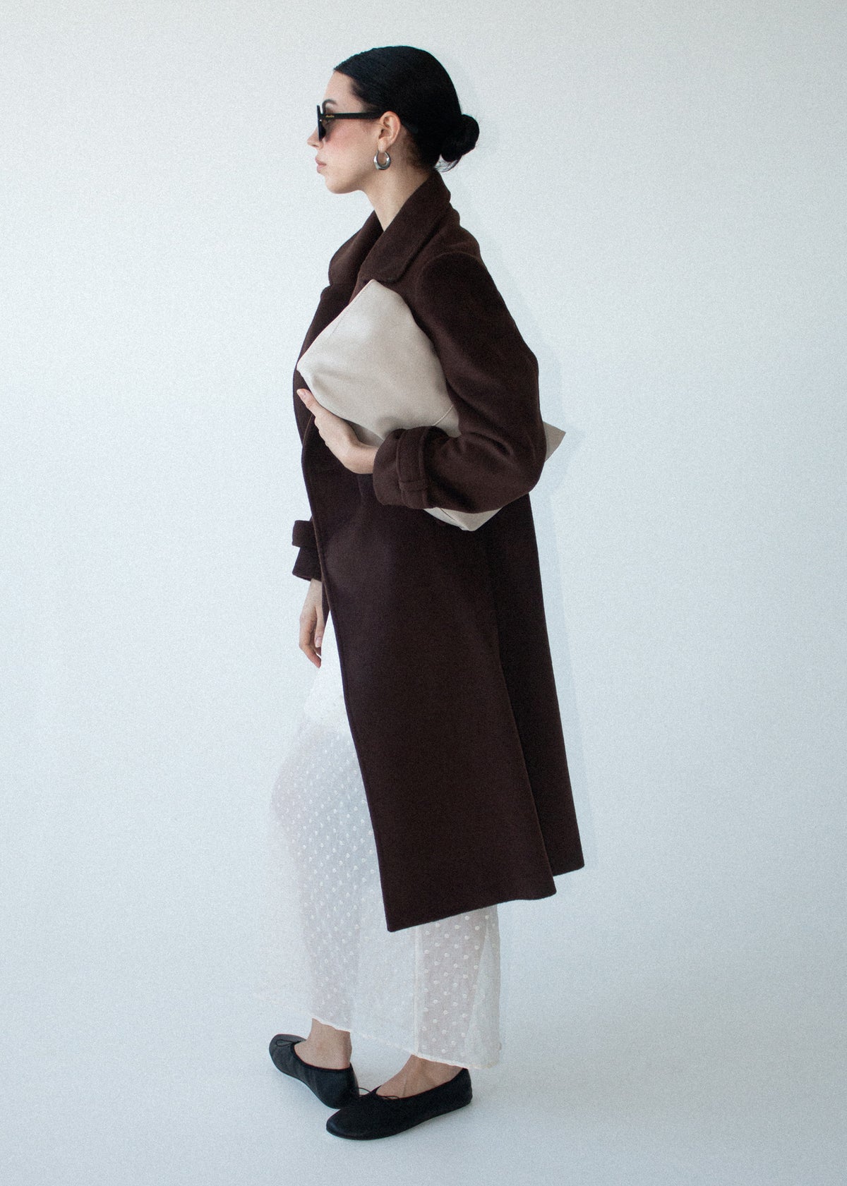 Side profile of the Brown Double-Breasted Longline Coat with a longline length and a rich chocolate brown tone.